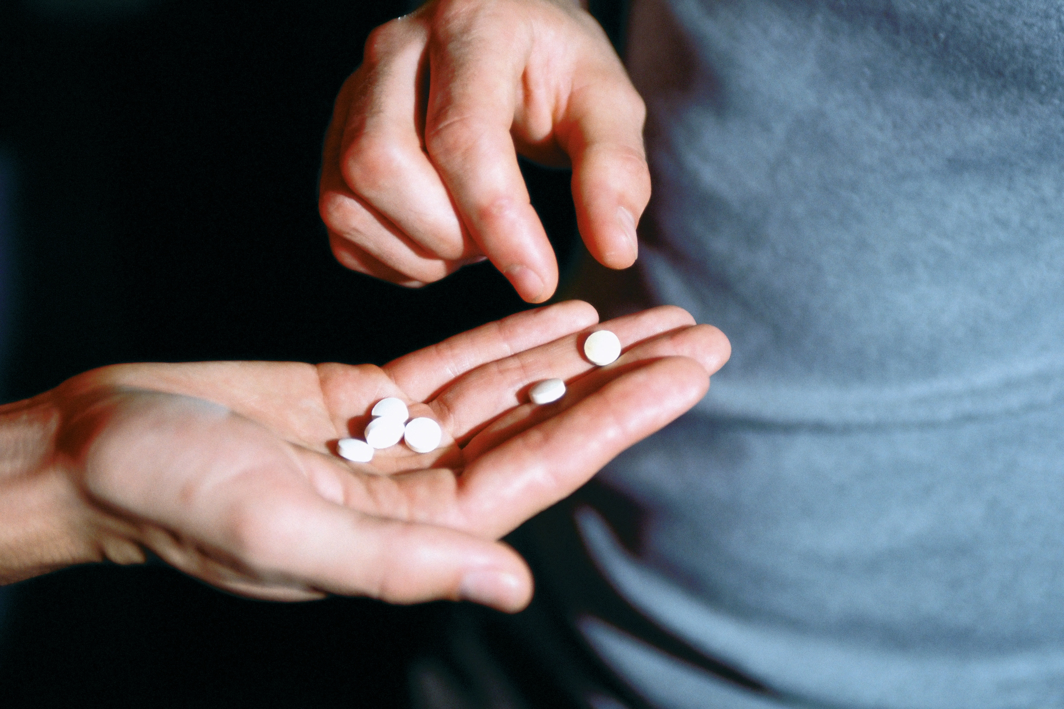 Male hand holding recreational drugs