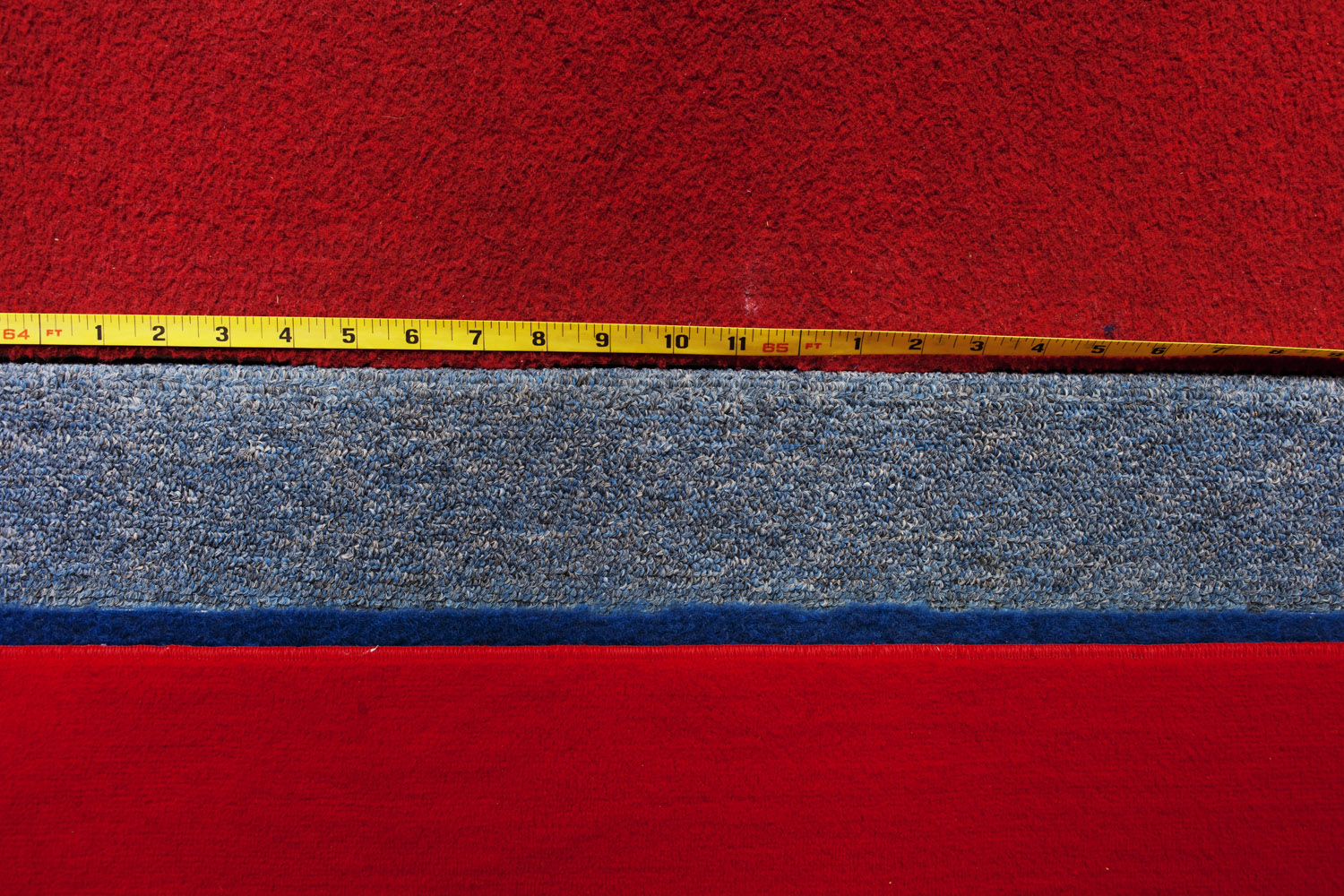 A measuring tape on the side of the runway to the vault in the Olympic training area.
