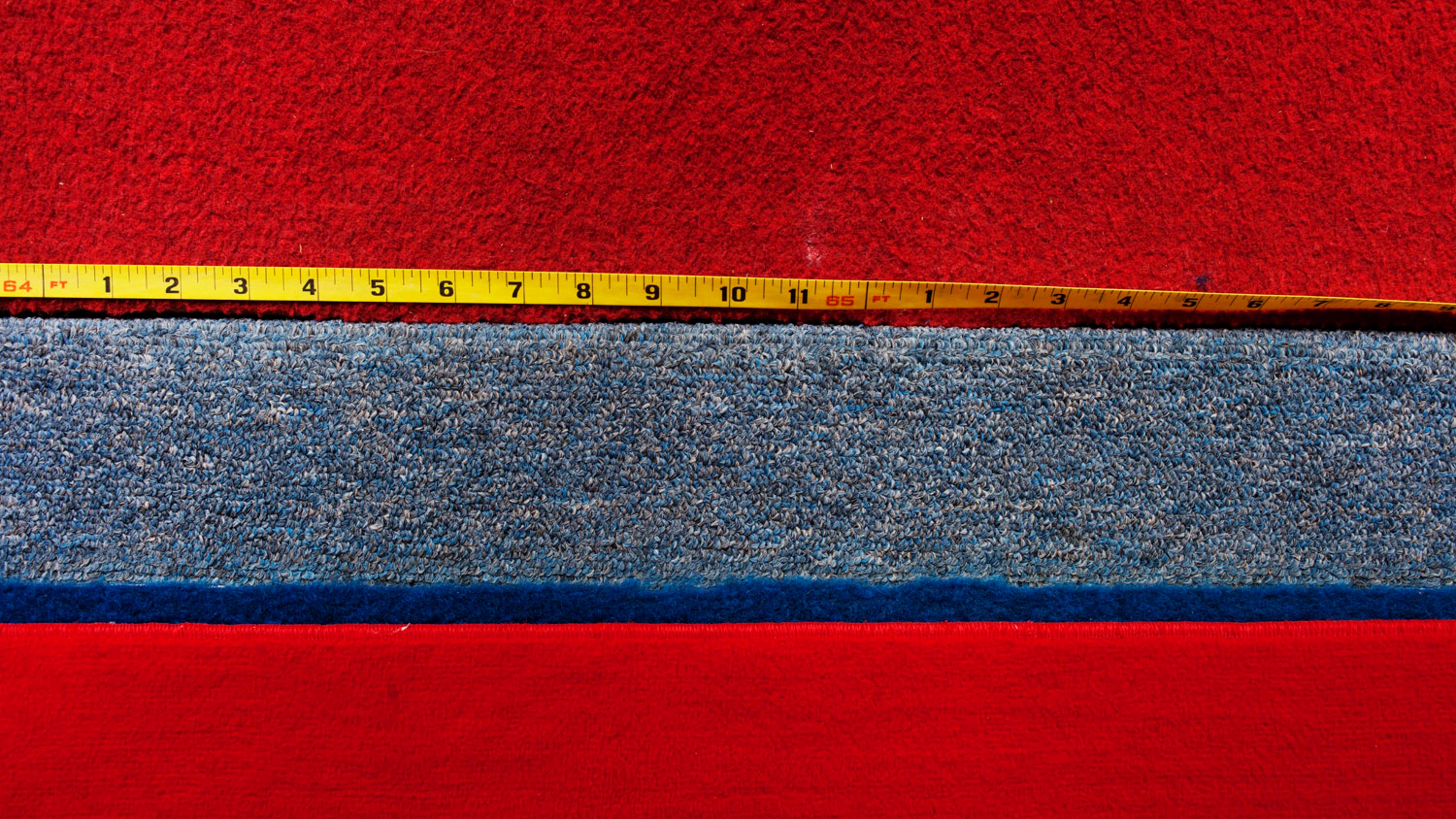 A measuring tape on the side of the runway to the vault in the Olympic training area.