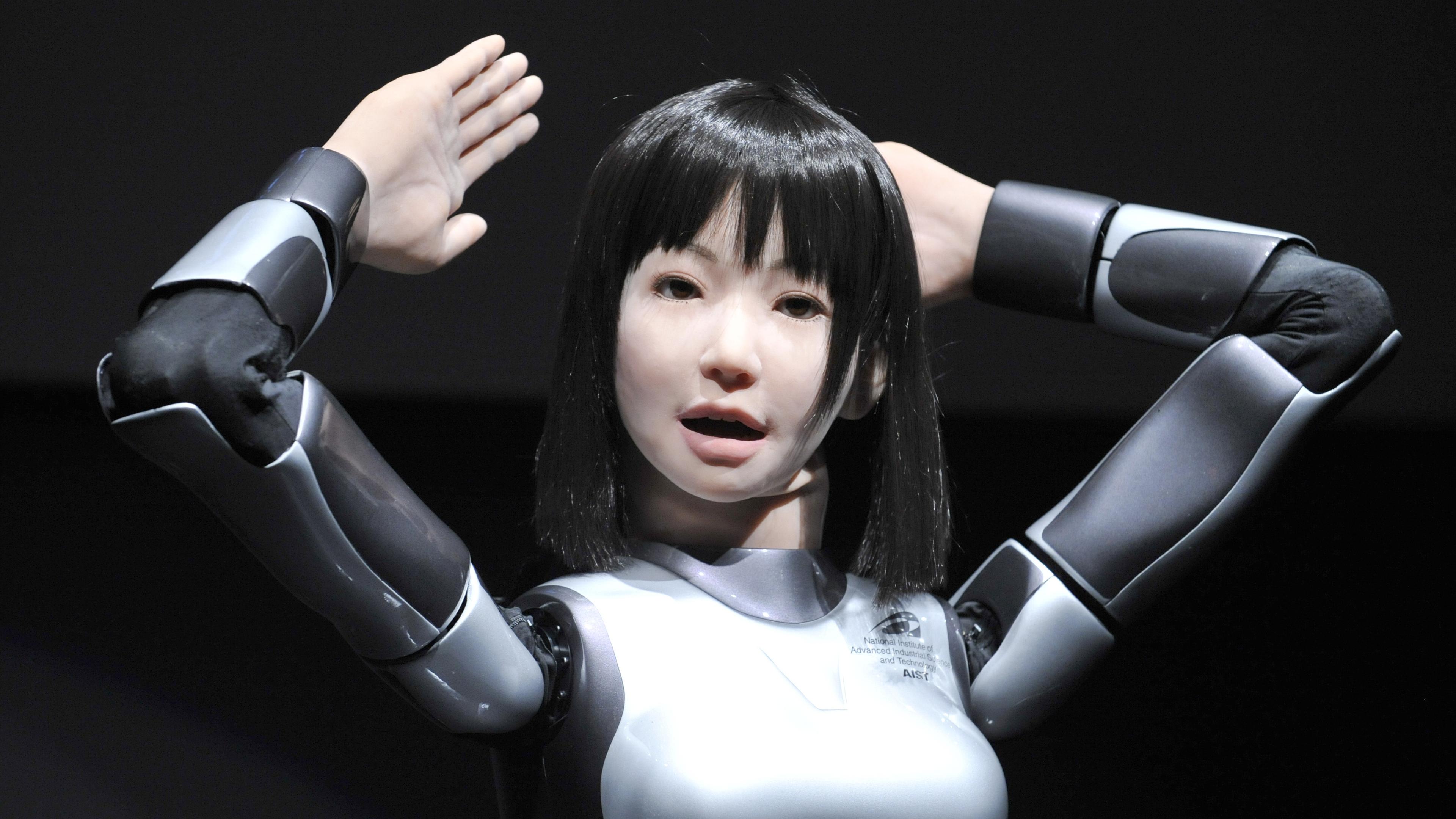 A humanoid robot, HRP-4C, developed by Japan's Advanced Industrial Science and Technology shows off her skills during the Digital Contents Expo in Tokyo on October 22, 2009.