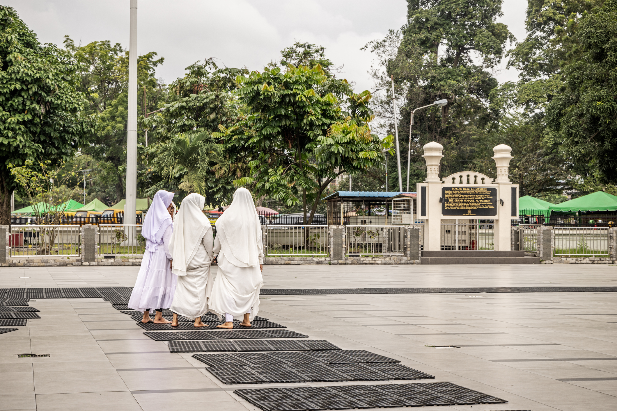 Women walking in the central yard in front of a mosque in Medan, Indonesia, on Jan. 16, 2024.