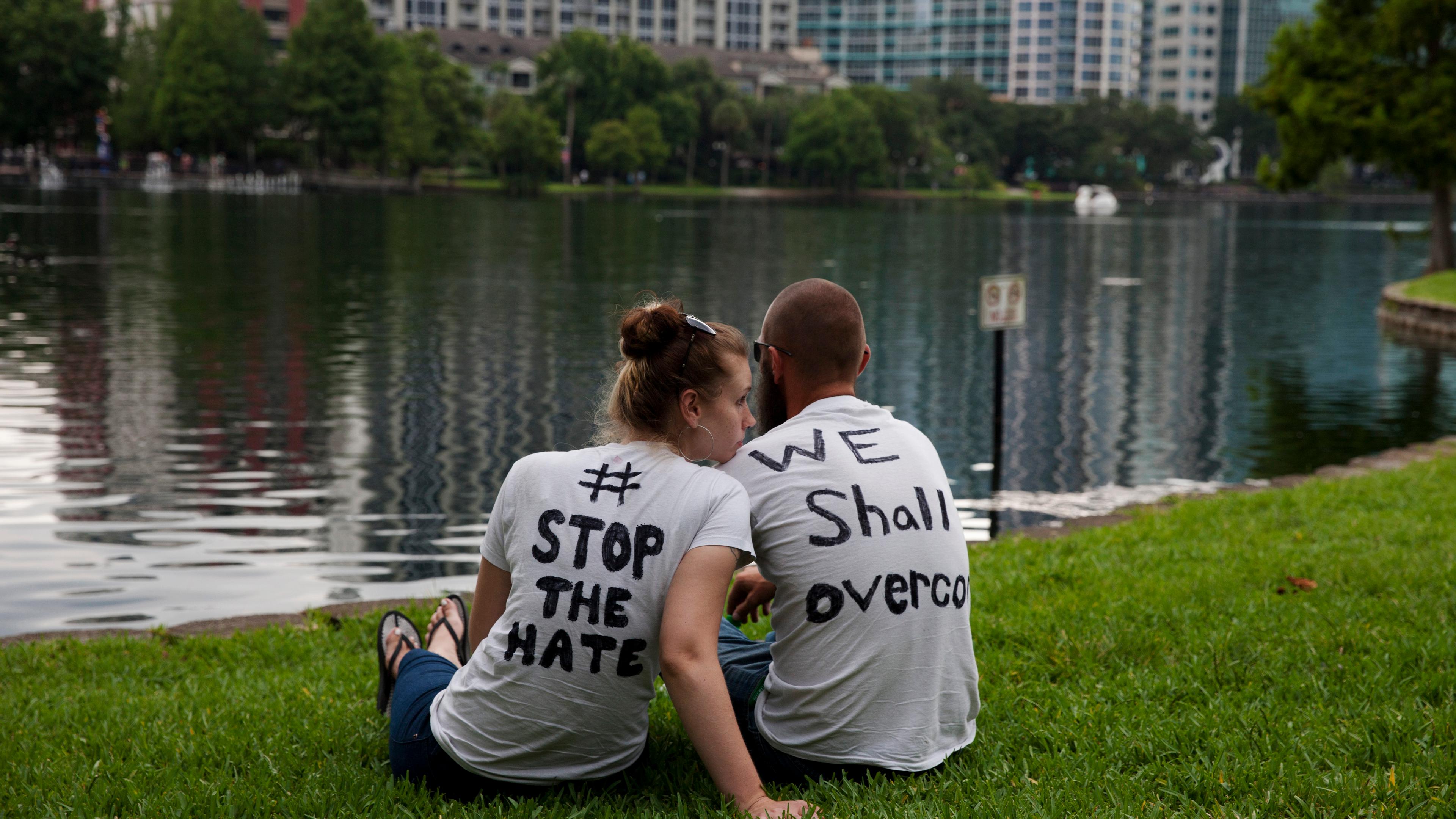 Mourners attend a makeshift vigil and a moment of silence for victims of the mass shooting in Orlando, Fla., on June 12, 2016.