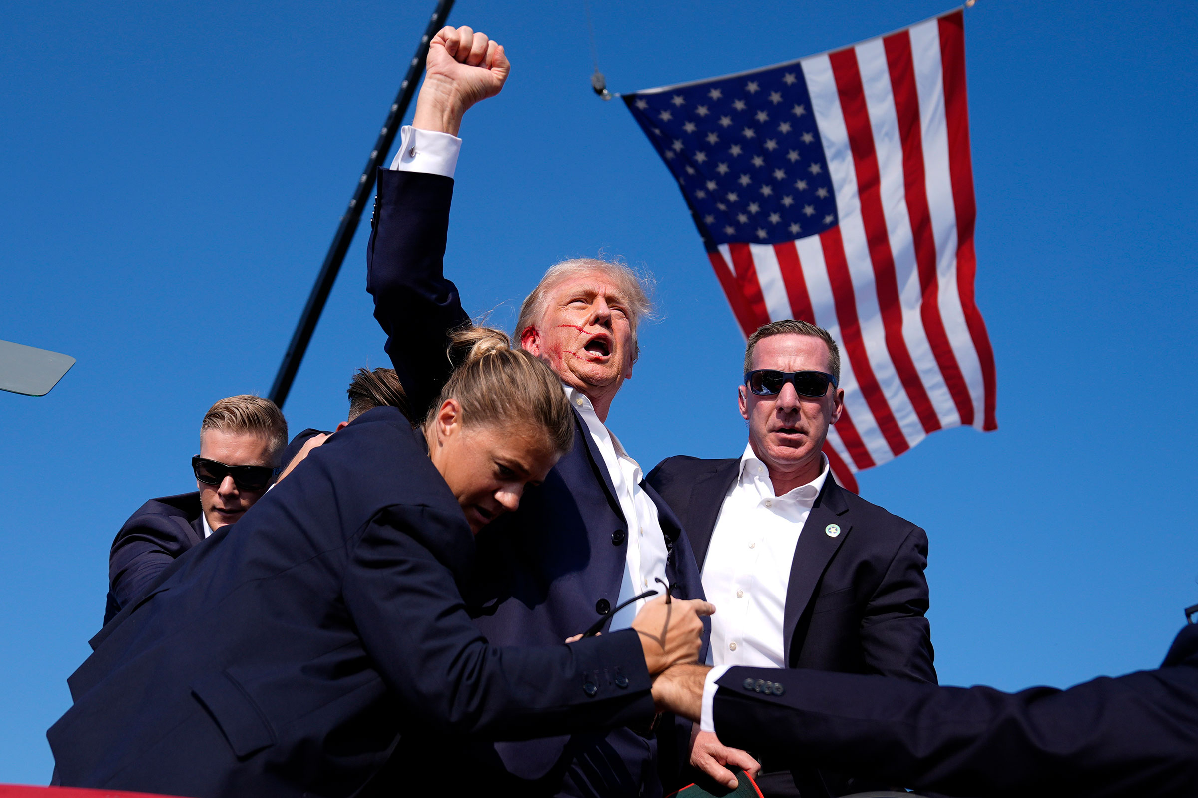 Donald Trump is surrounded by U.S. Secret Service agents at a campaign rally after an assassination attempt in Butler, Pa., on July 13.