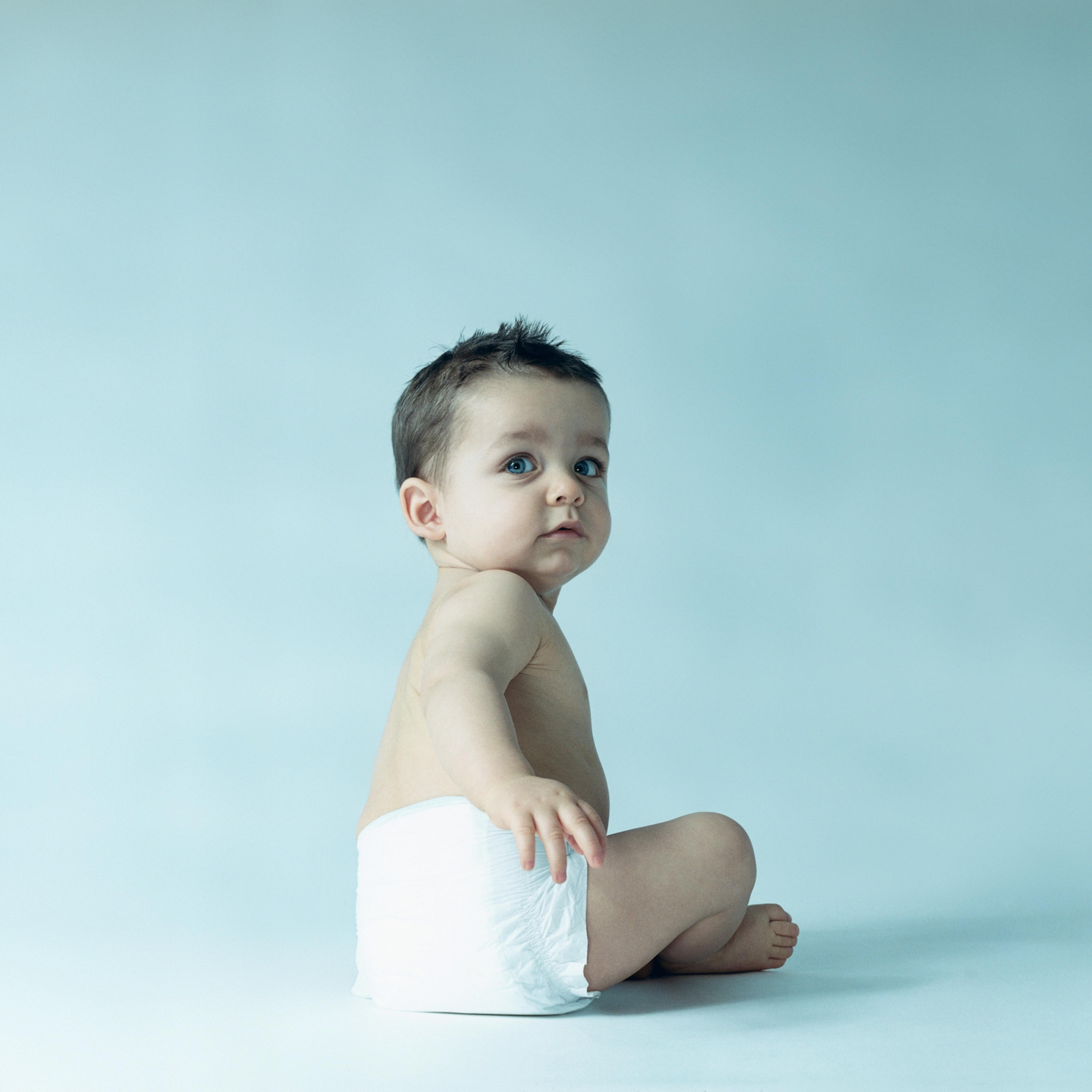 Baby boy looking over shoulder