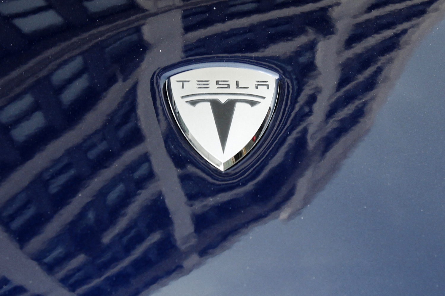 A logo of Tesla Motors on an electric car model is seen outside a showroom in New York