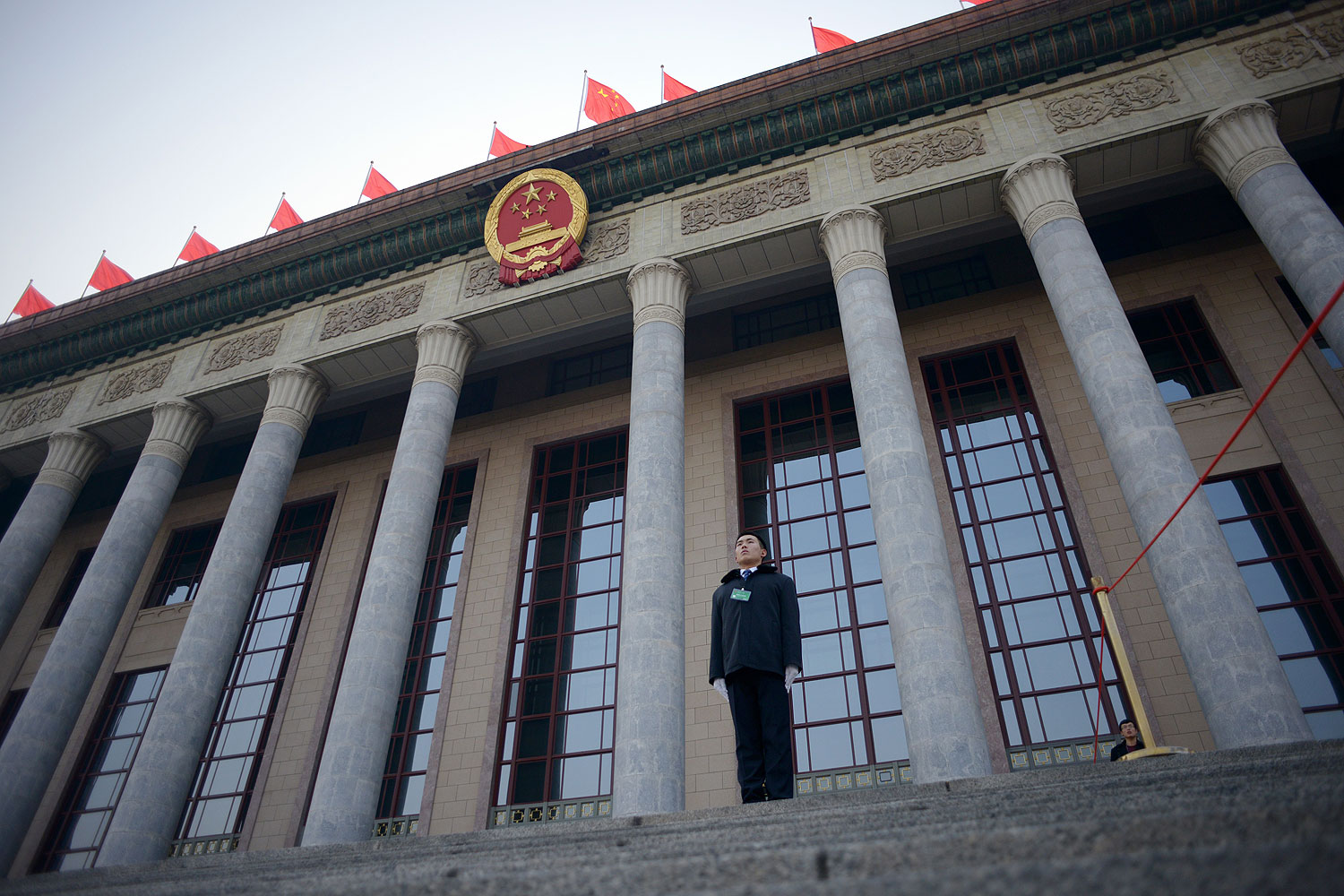 A security guard stands in front of The Great Hall of the People before the upcoming opening sessions of the National People's Congress (NPC) in Beijing on Mar. 2, 2014