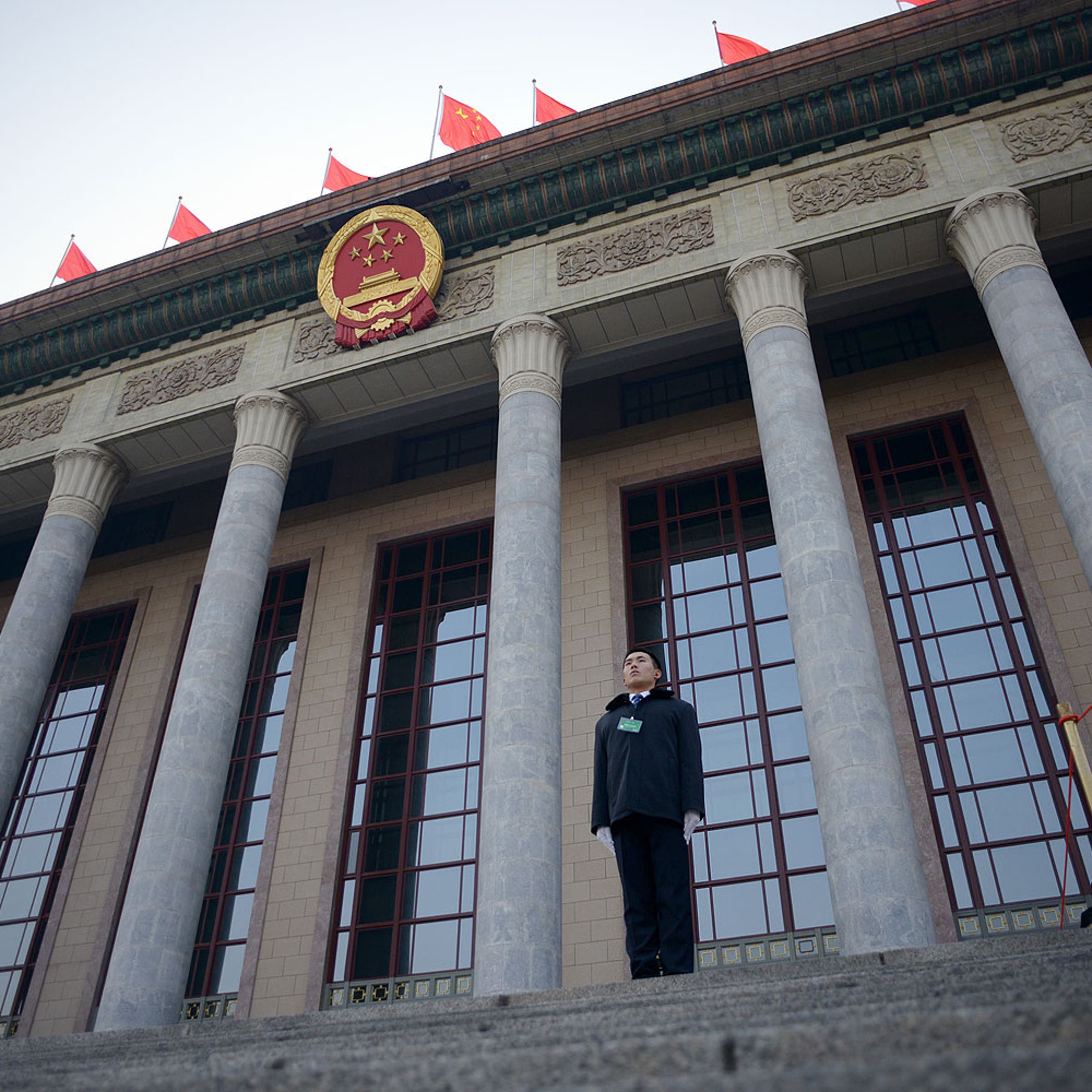 A security guard stands in front of The Great Hall of the People before the upcoming opening sessions of the National People's Congress (NPC) in Beijing on Mar. 2, 2014