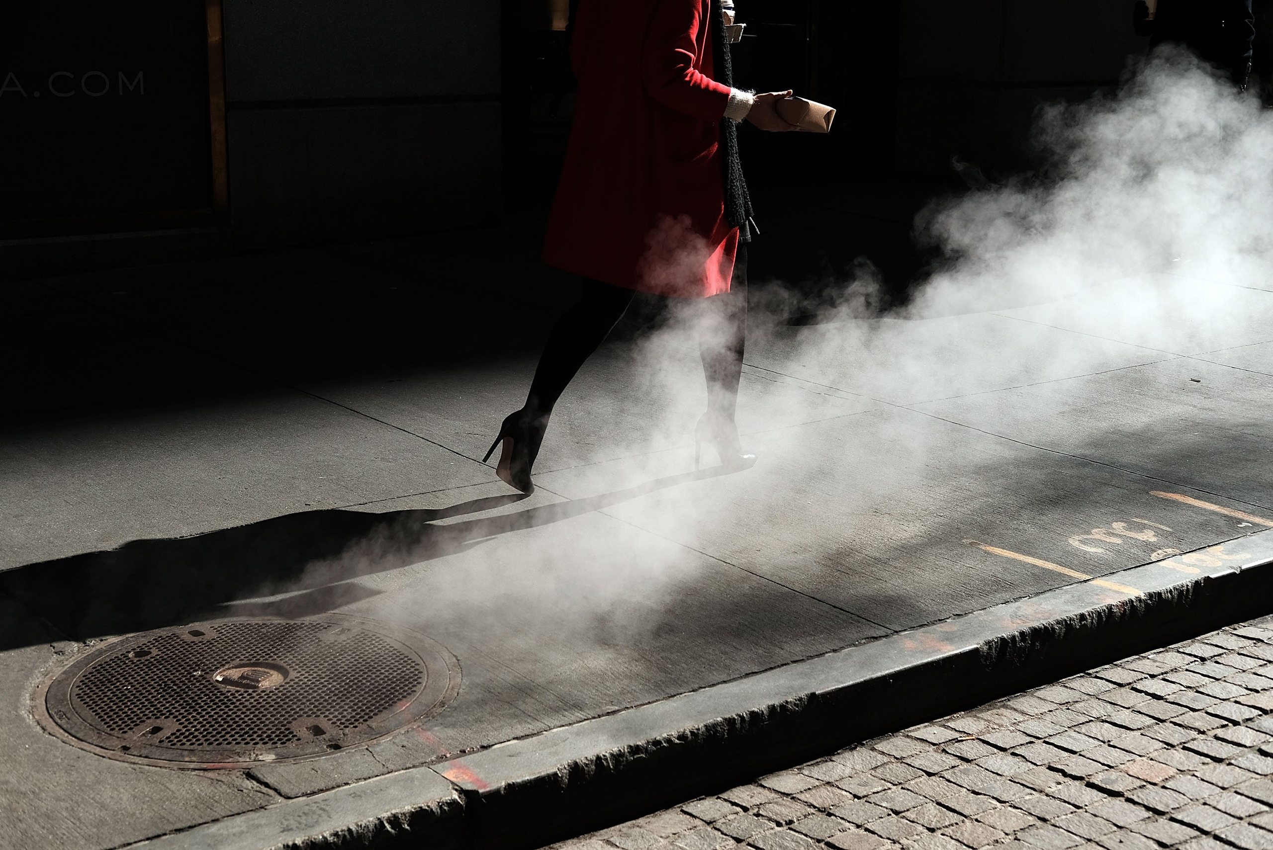 NEW YORK, NY - MARCH 21: A woman walks by the New York Stock Exchange (NYSE) near Wall Street on March 21, 2016 in New York City. Following a strong week for US stocks, the Dow Jones industrial average was down slightly in morning trading. (Photo by Spen