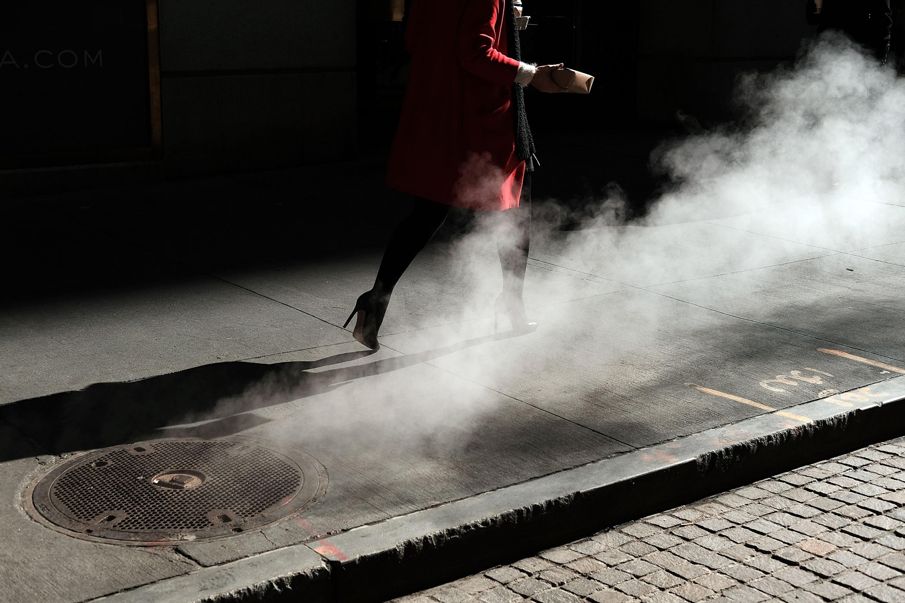 NEW YORK, NY - MARCH 21: A woman walks by the New York Stock Exchange (NYSE) near Wall Street on March 21, 2016 in New York City. Following a strong week for US stocks, the Dow Jones industrial average was down slightly in morning trading. (Photo by Spen