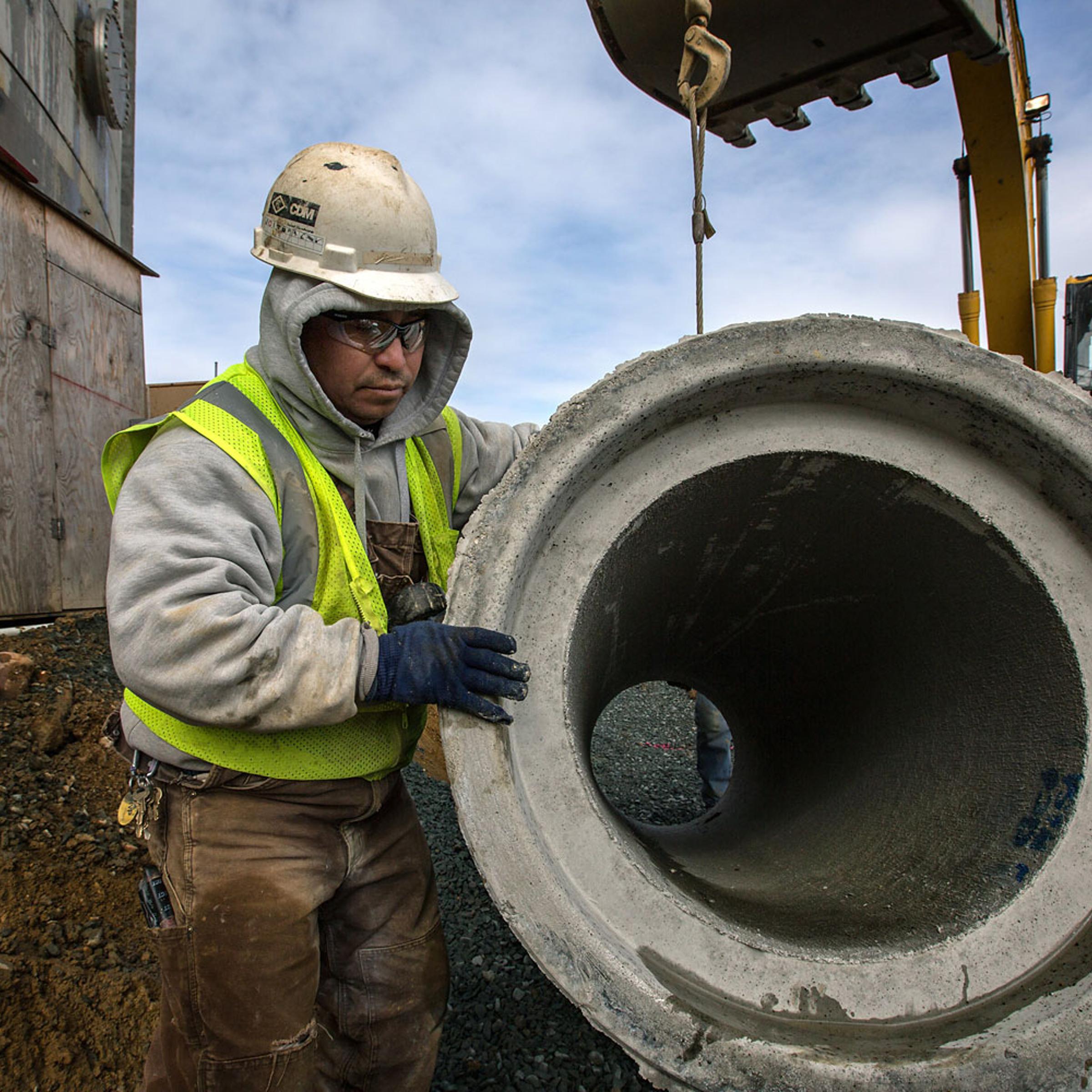 Construction worker installs storm water drain pipes at a hydrolysis wastewater treatment project in Washington, D.C., March 18, 2014.