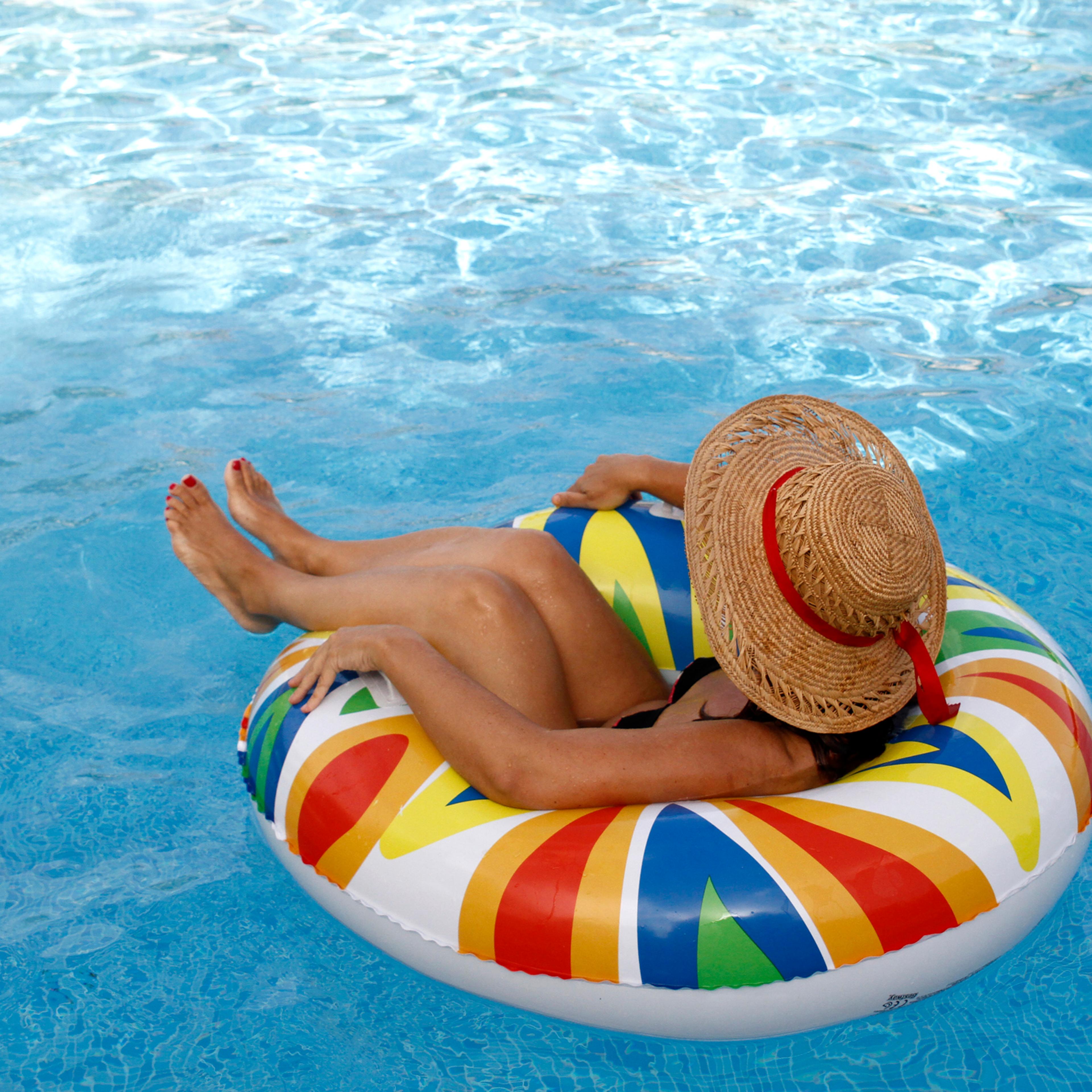 Woman resting on inflatable ring at pool