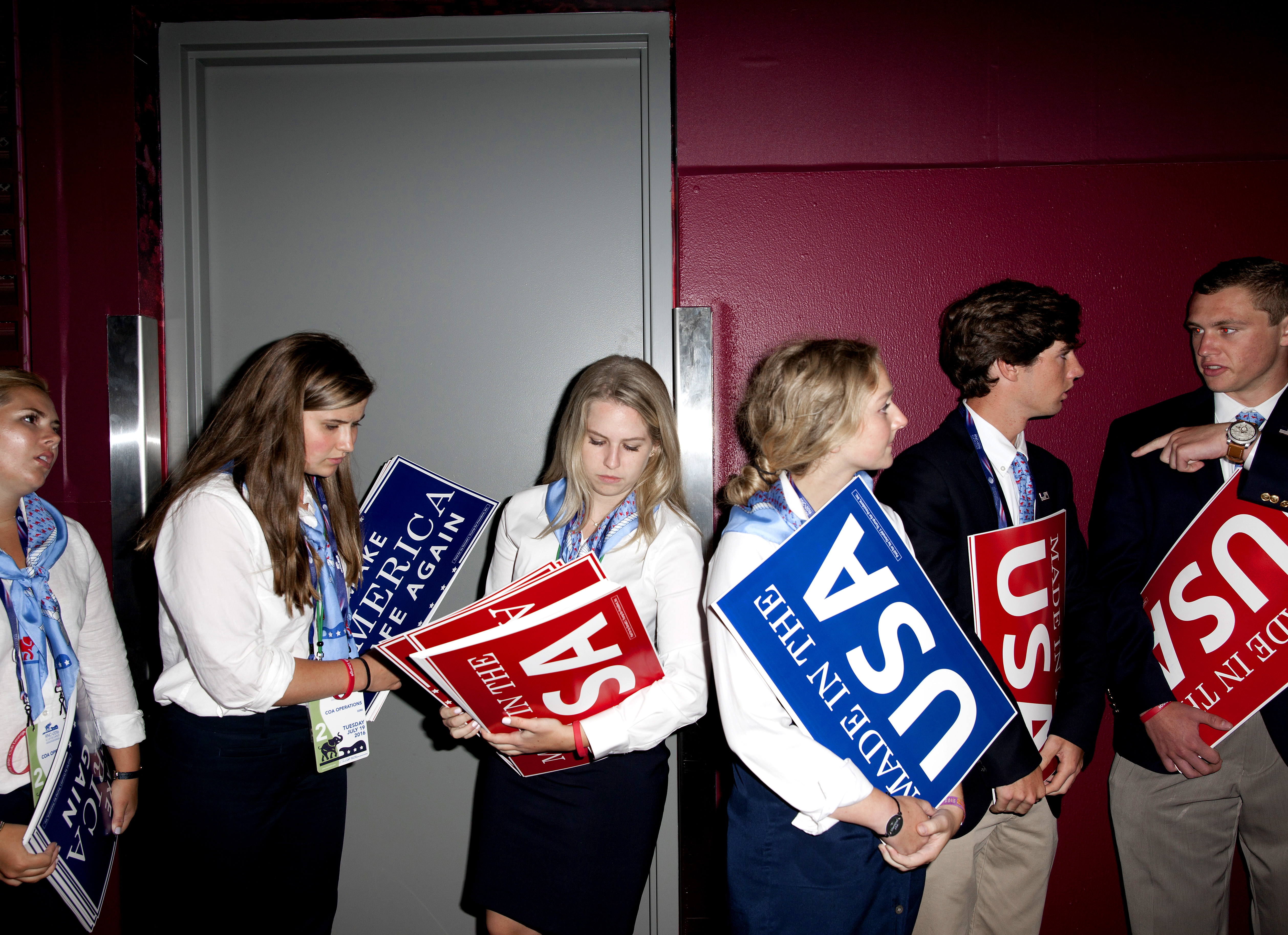 Attendees hold signs at the Republican National Convention in Cleveland on Tuesday, July 19, 2016.