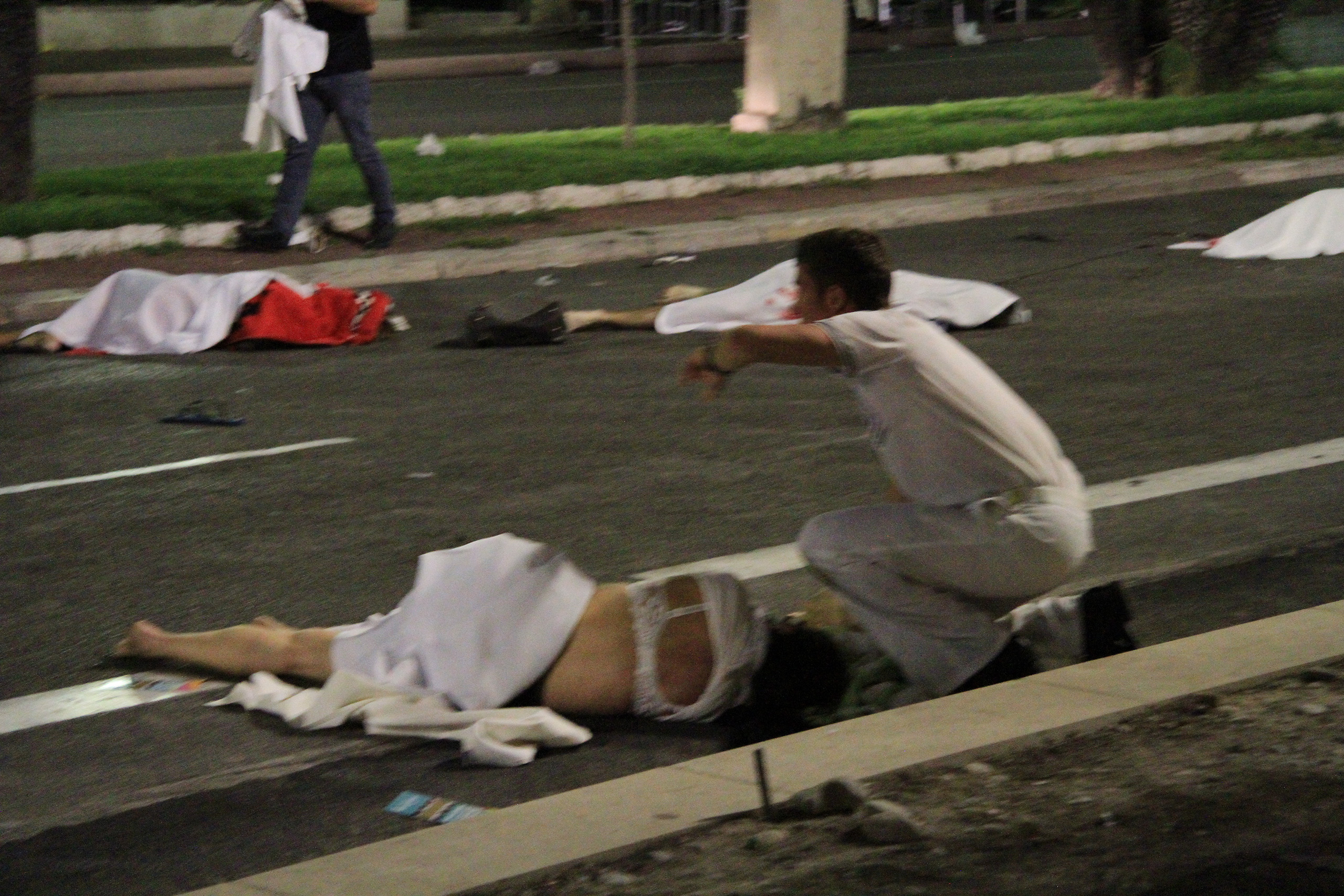 First responders tend to victims of a terrorist attack in Nice, France, that left at least 77 dead and dozens injured on July 14, 2016.