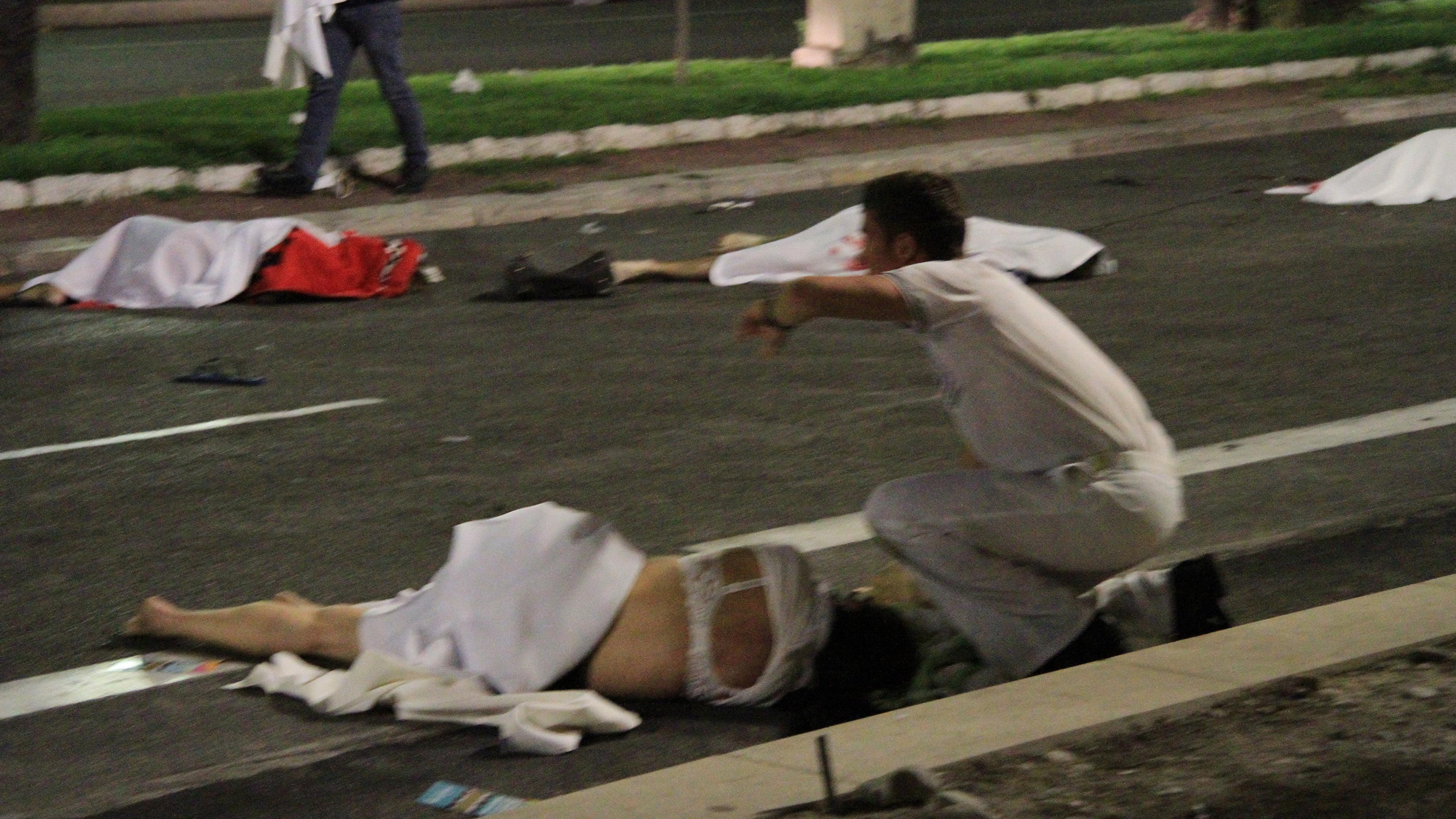 First responders tend to victims of a terrorist attack in Nice, France, that left at least 77 dead and dozens injured on July 14, 2016.