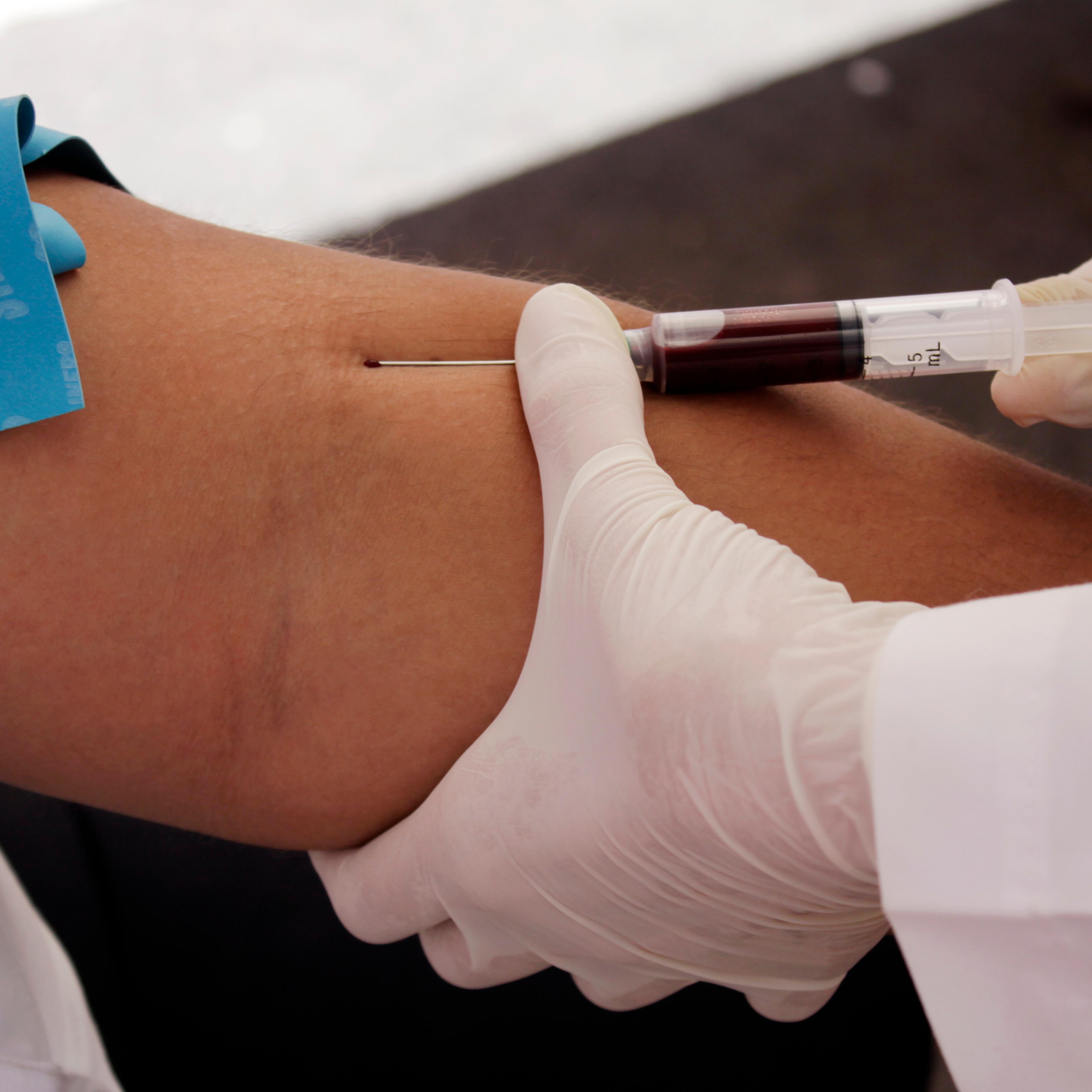 A nurse takes blood for a free HIV test, during an HIV/AIDS awareness rally on World AIDS Day in San Salvador