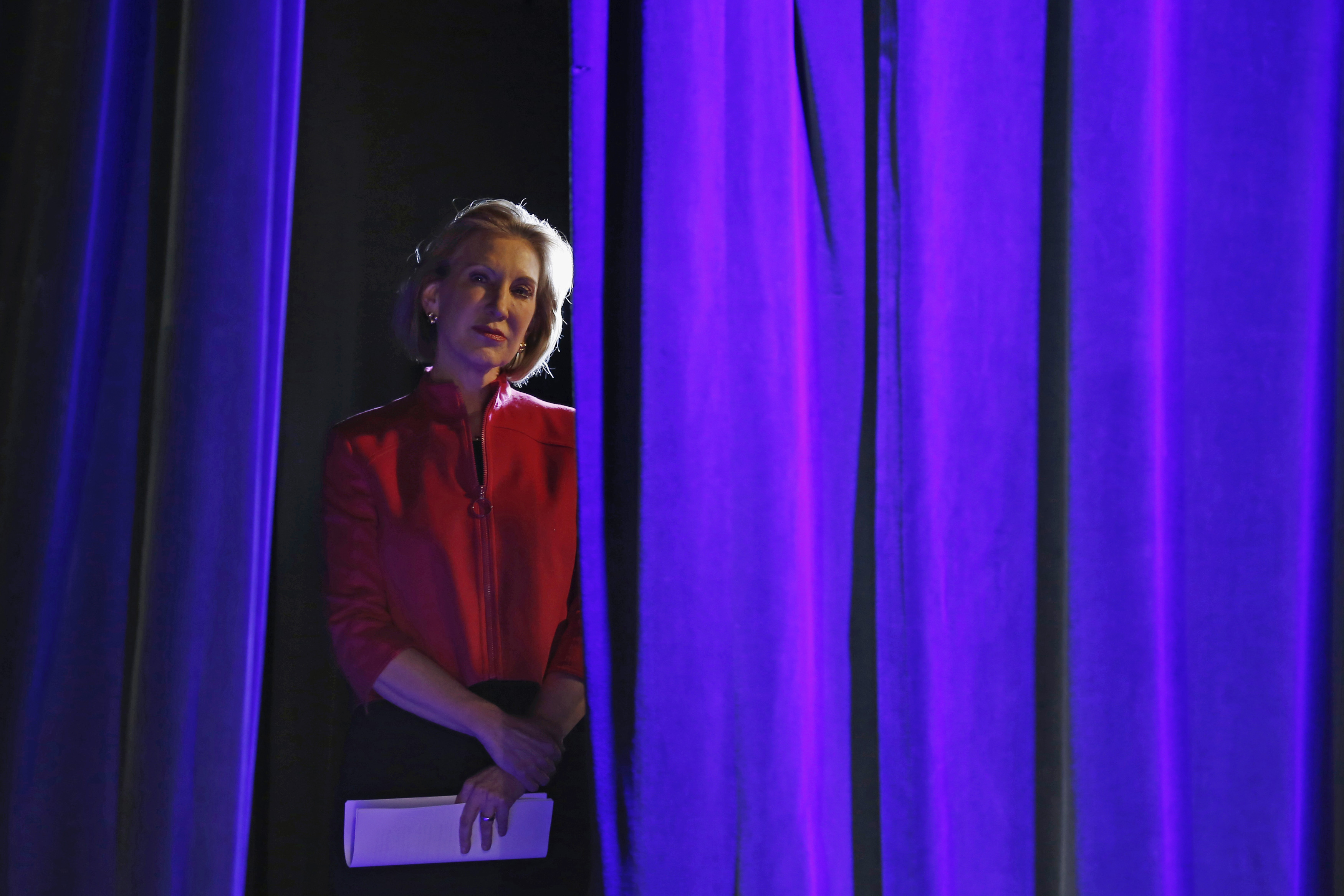 Former Hewlett-Packard Co Chief Executive Officer Carly Fiorina listens to her introduction from the side of the stage at the Freedom Summit in Des Moines, Iowa on Jan. 24, 2015.