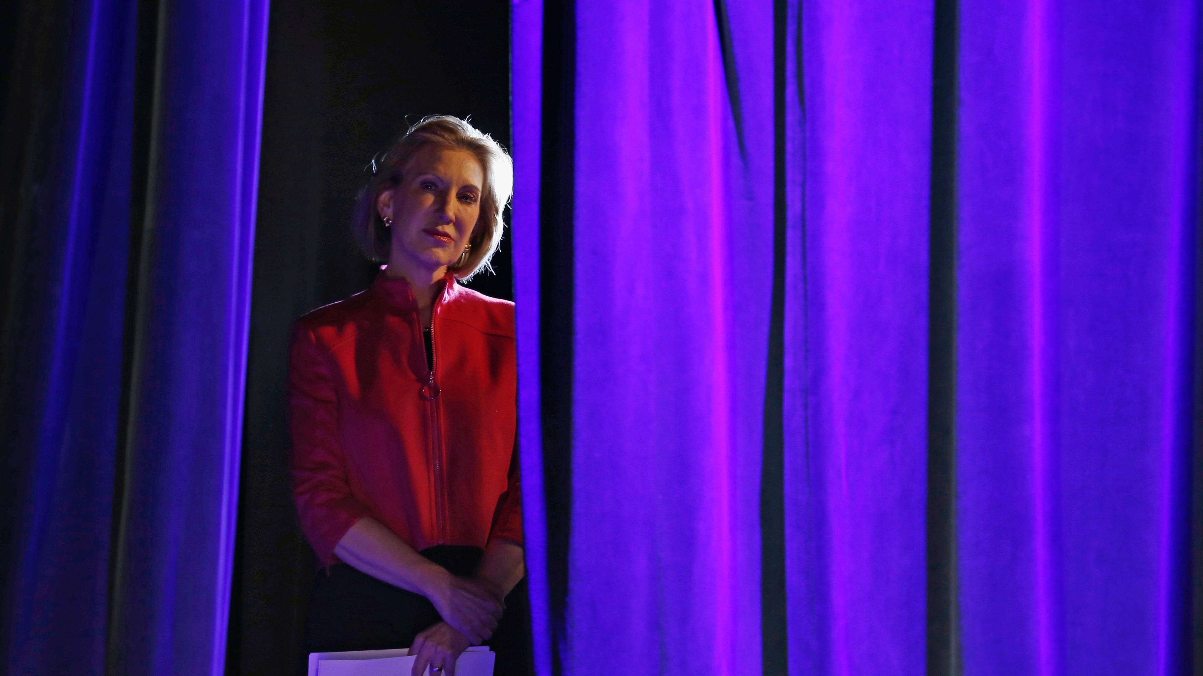 Former Hewlett-Packard Co Chief Executive Officer Carly Fiorina listens to her introduction from the side of the stage at the Freedom Summit in Des Moines, Iowa on Jan. 24, 2015.