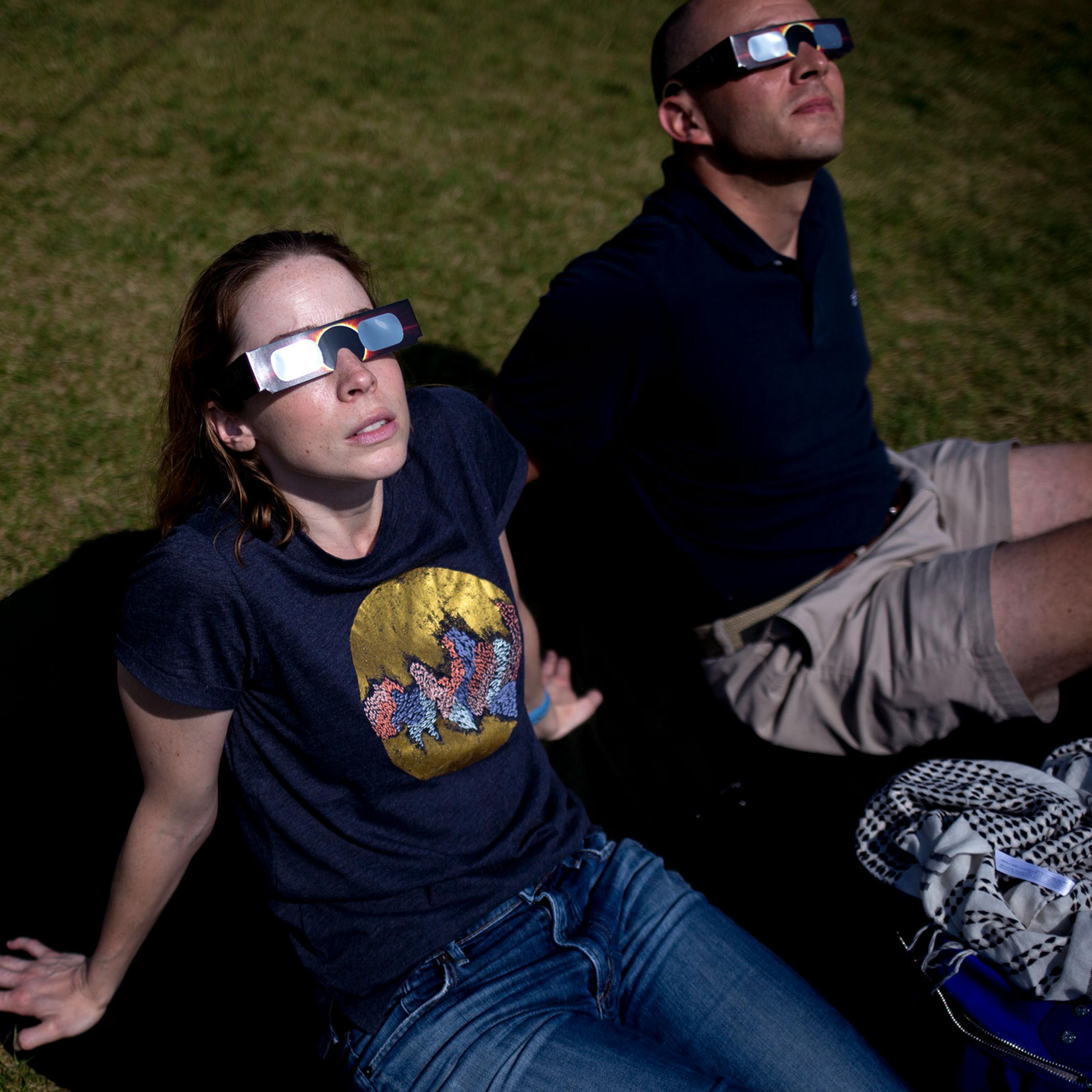 People watch the partial solar eclipse at in Freeport, Maine.