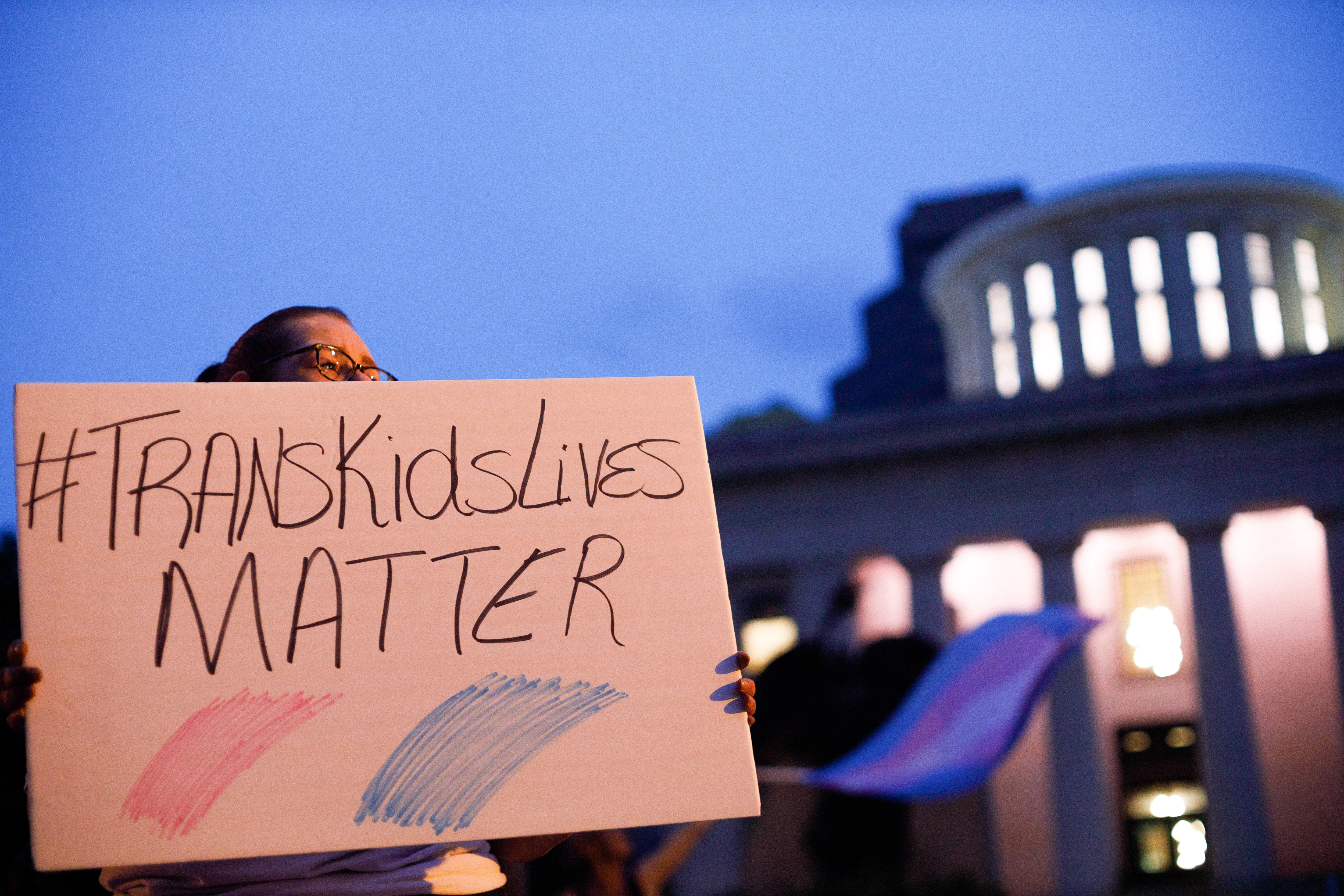 Transgender rights advocate holds a sign