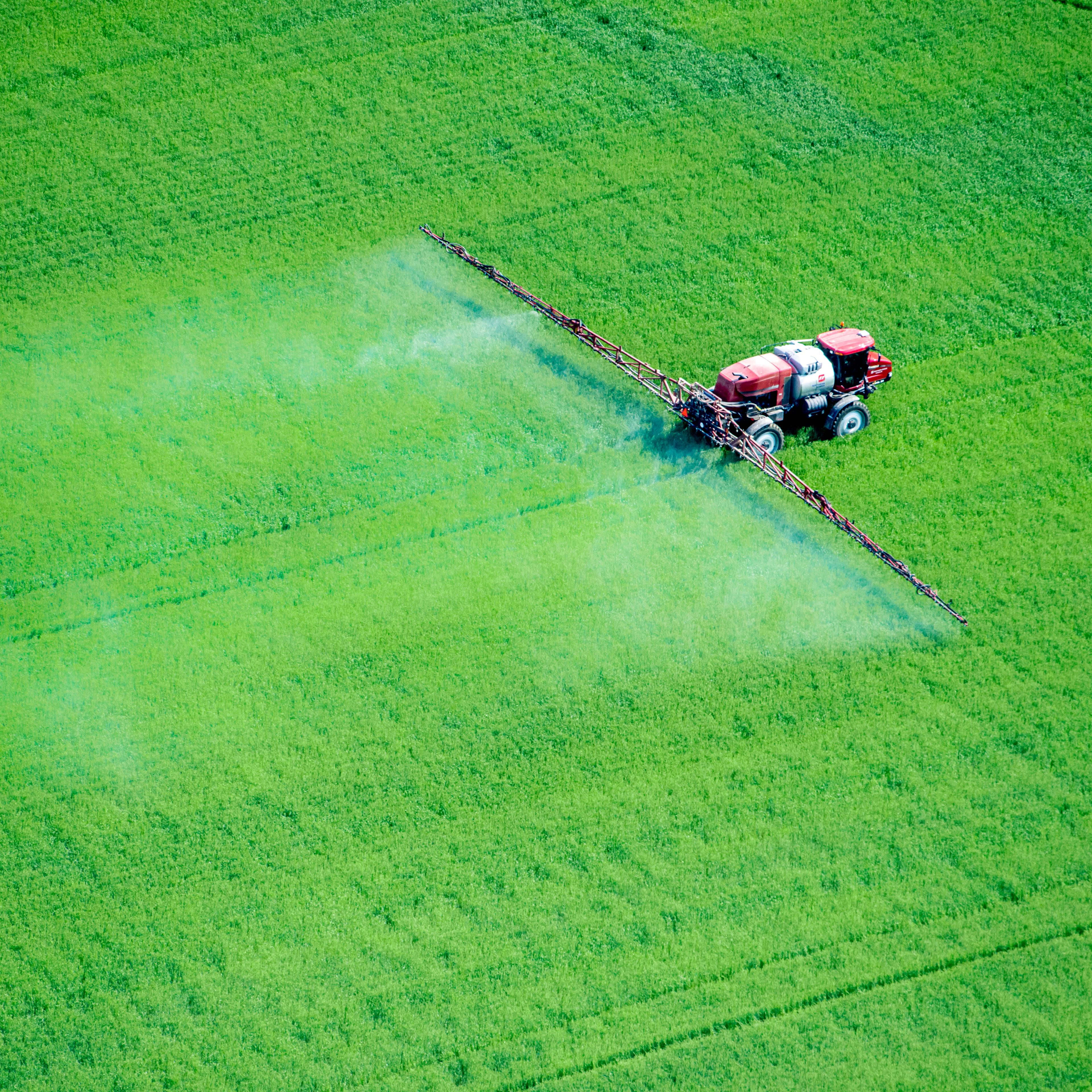 Aerial of spray application in green agricultural field on the eastern shore of Maryland, USA
