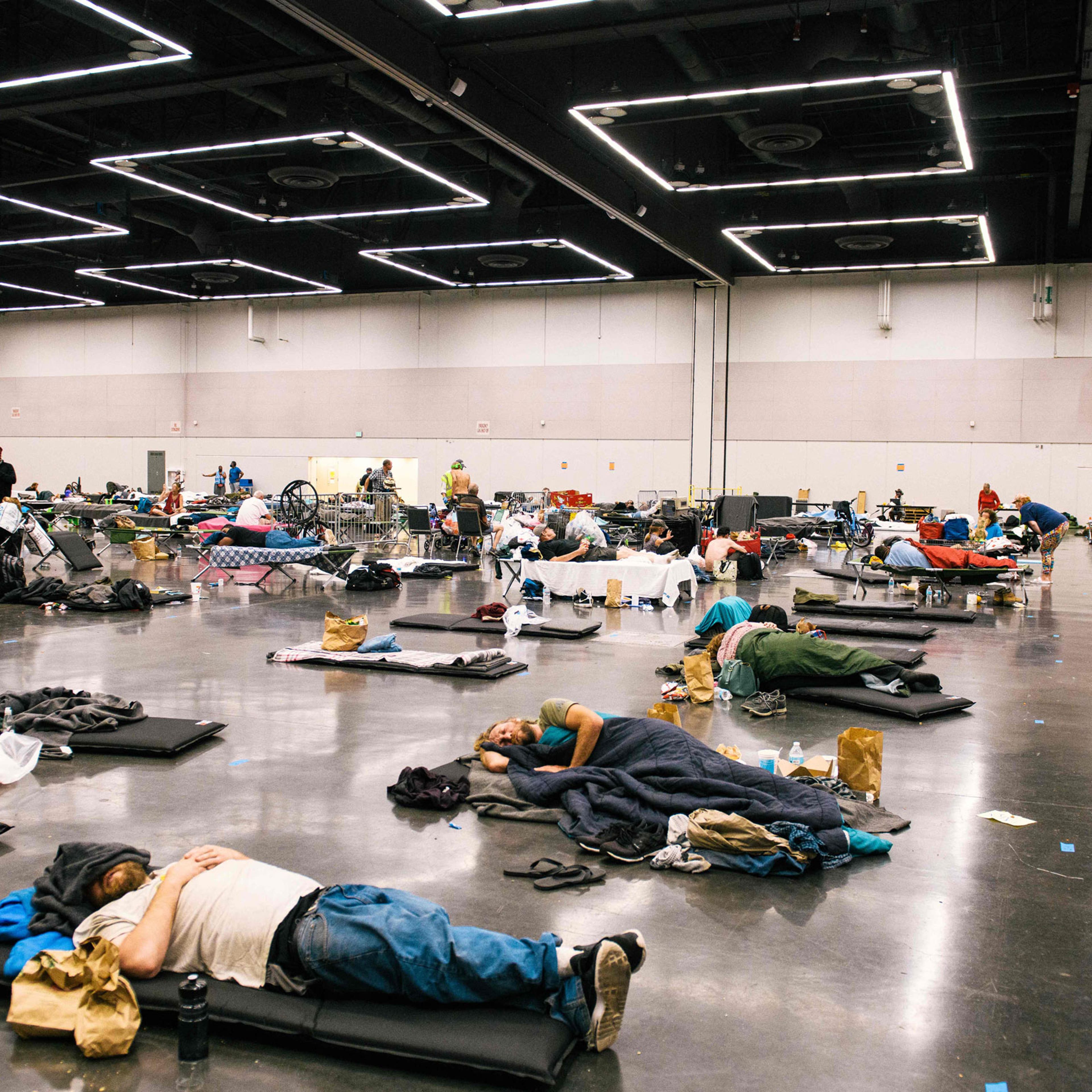 People rest at the Oregon Convention Center cooling station in Portland, Ore., on June 28, 2021