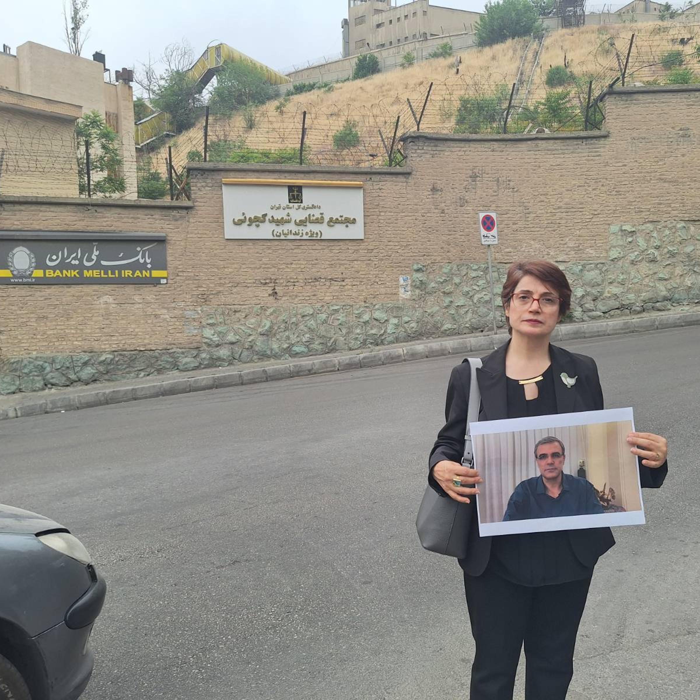 Iranian human rights attorney and activist Nasrin Satoudeh holds a photo of her husband outside Tehran's Evin Prison, where he is an inmate. Reza Khandan was taken into custody in December on charges of making buttons reading "I Oppose the Mandatory Hijab" and otherwise supporting women's rights. His wife has spent six years behind bars on similar charges. "Today was the day I’m supposed to be able to meet Reza," she said, "but as usual they prevented me from seeing him because I wasn't wearing a hijab."