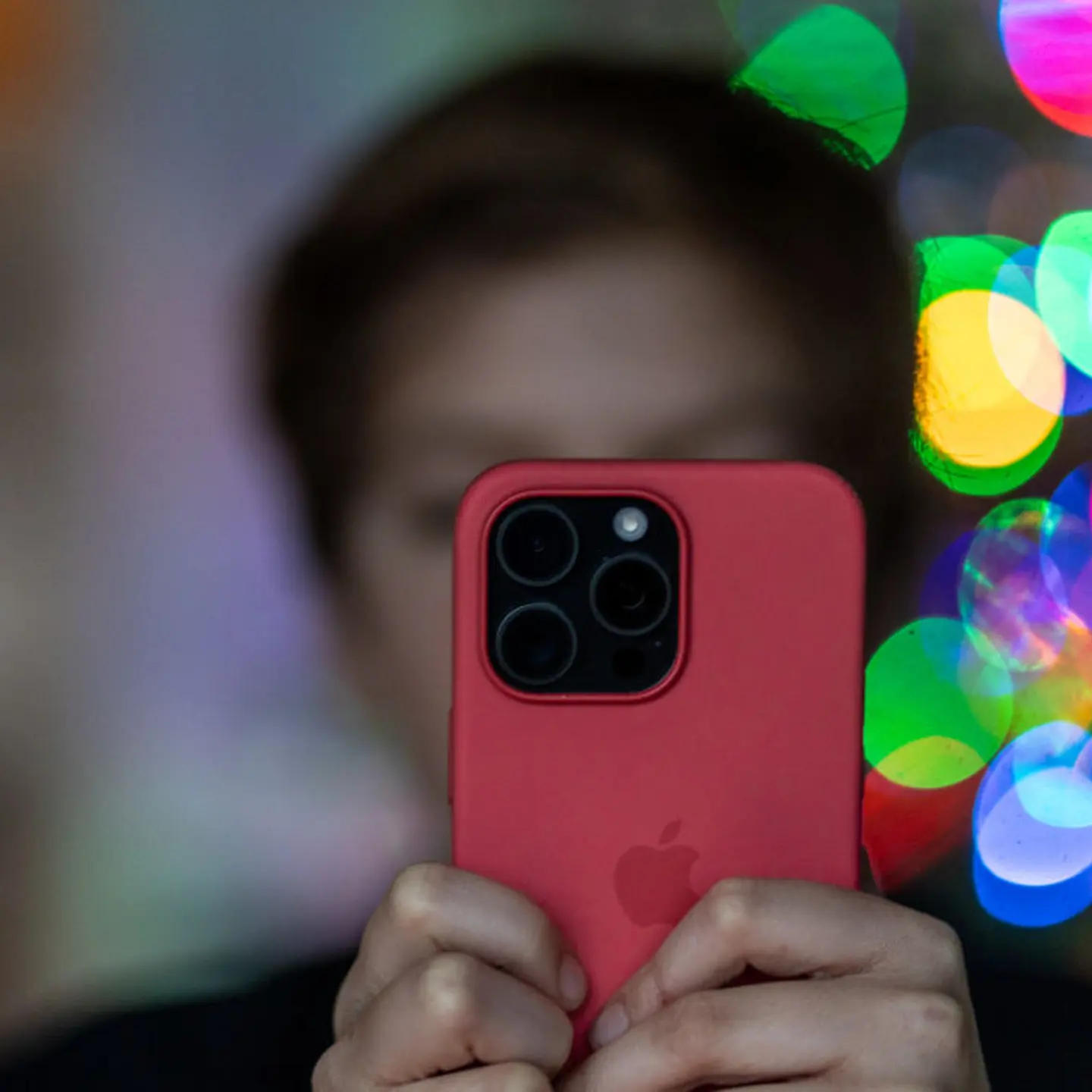 A 12-year-old boy looks at an iPhone screen on Dec. 19, 2023 in Bath, England.