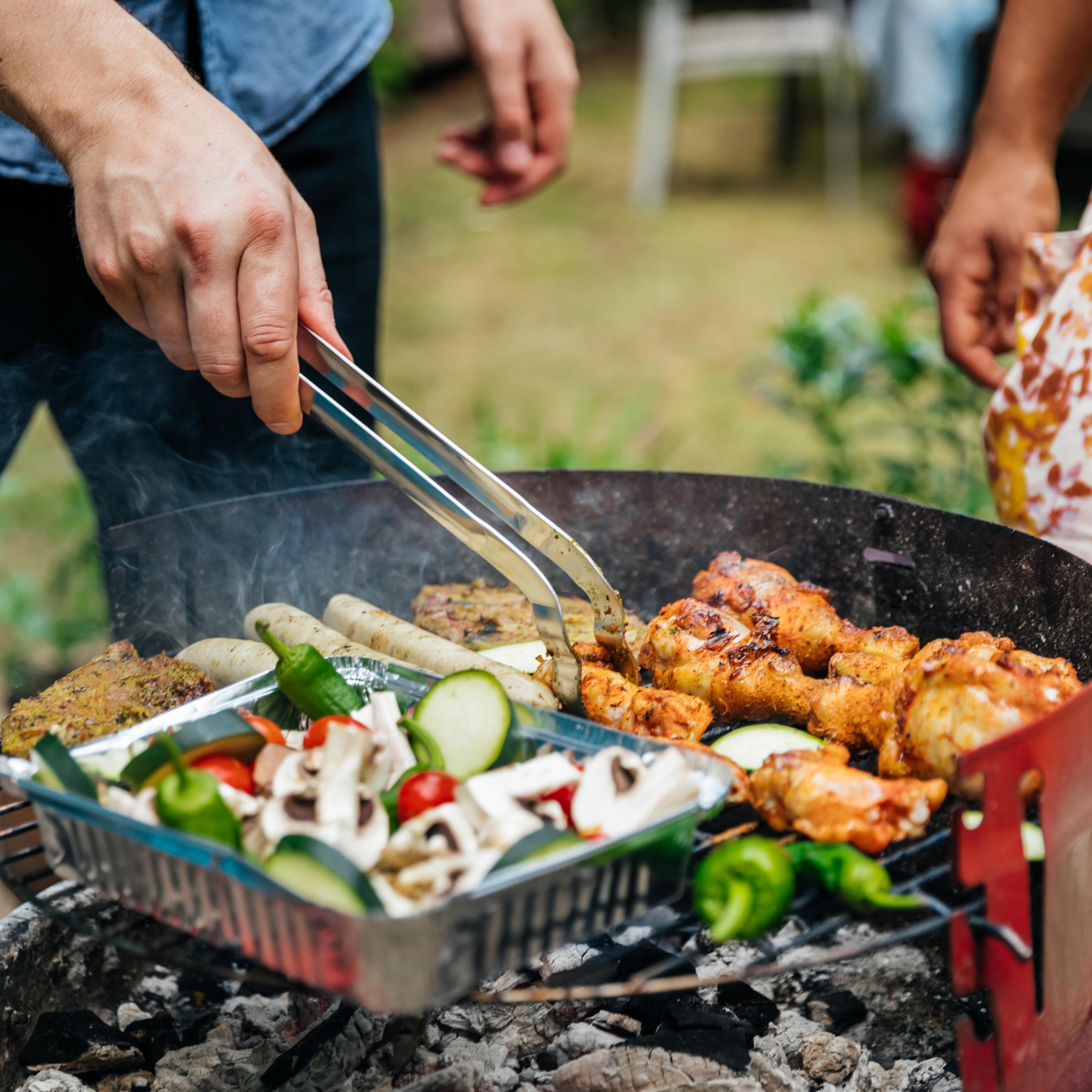 Close Up Of man Cooking Food On BBQ