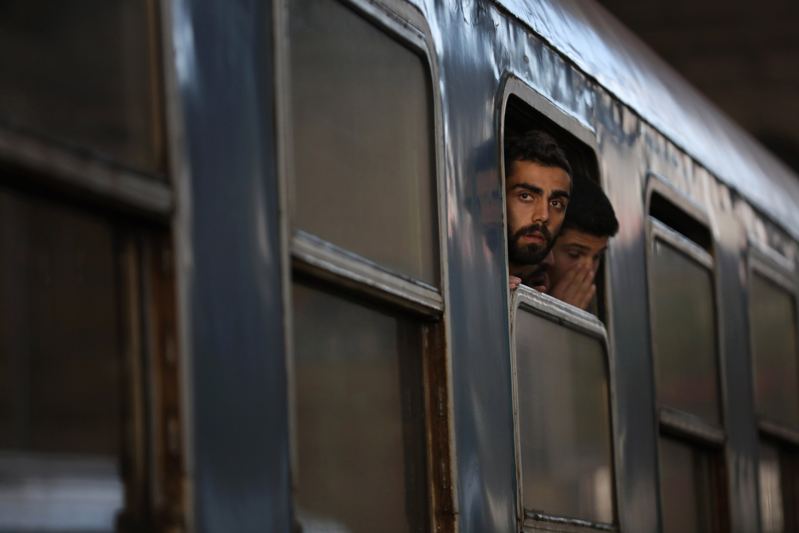 BUDAPEST, HUNGARY - SEPTEMBER 06: Migrants board a train at Keleti station in central Budapest to take them to the Austrian border on September 6, 2015 in Budapest, Hungary. Migrants are now making their own way by train and across country by foot as Aus