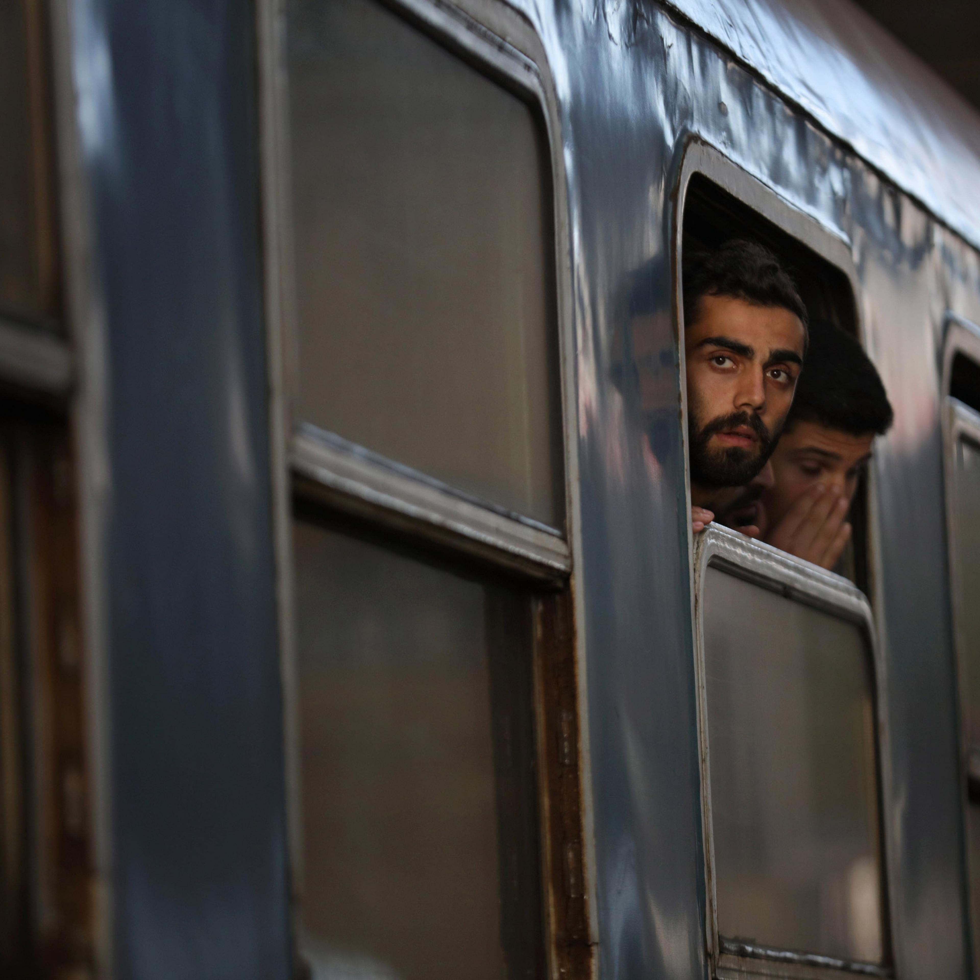 BUDAPEST, HUNGARY - SEPTEMBER 06: Migrants board a train at Keleti station in central Budapest to take them to the Austrian border on September 6, 2015 in Budapest, Hungary. Migrants are now making their own way by train and across country by foot as Aus