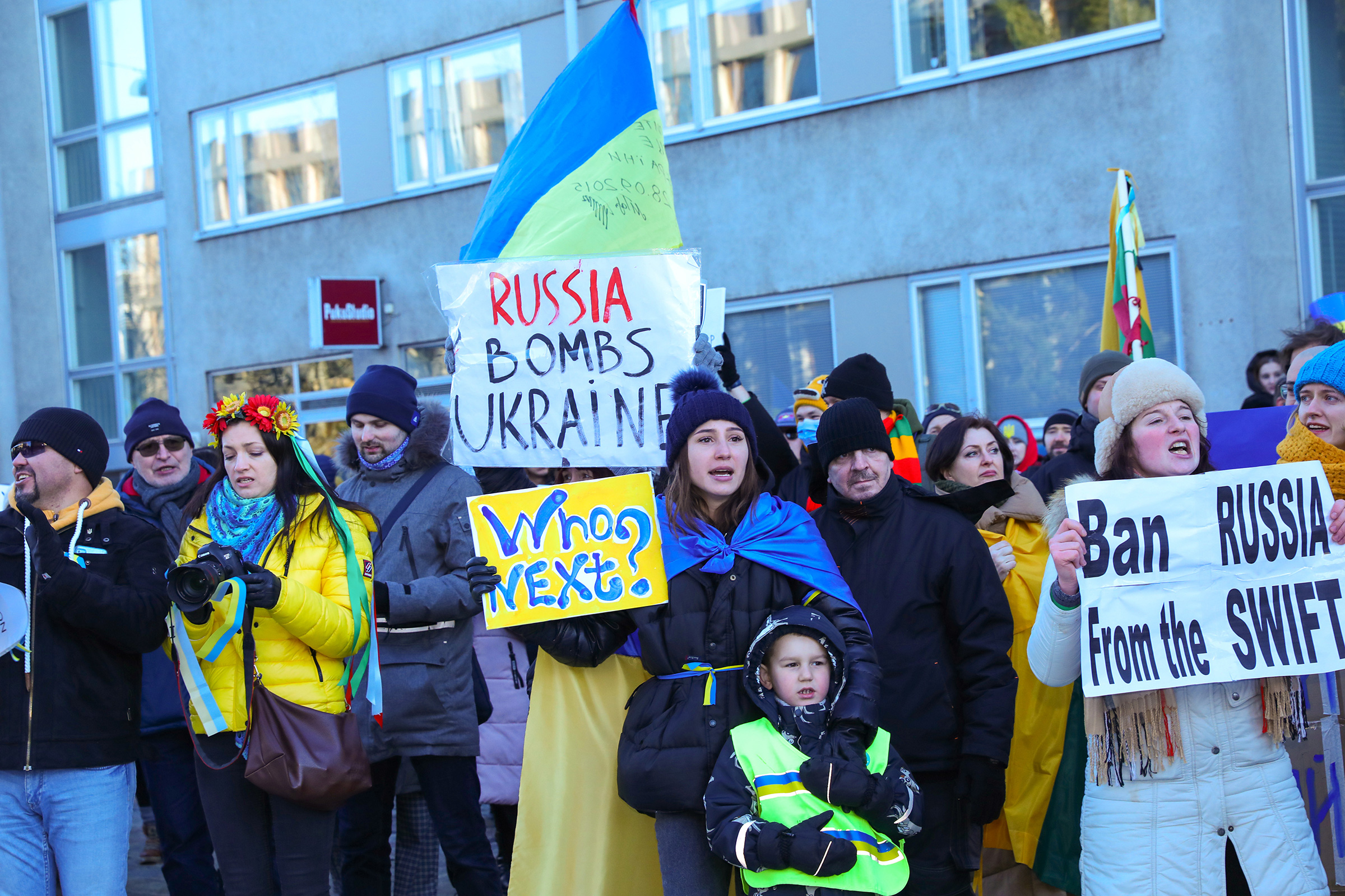 Protesters hold placards during an anti-war protest in front of the Embassy of Russia in Helsinki, Finland, Feb. 26, 2022.