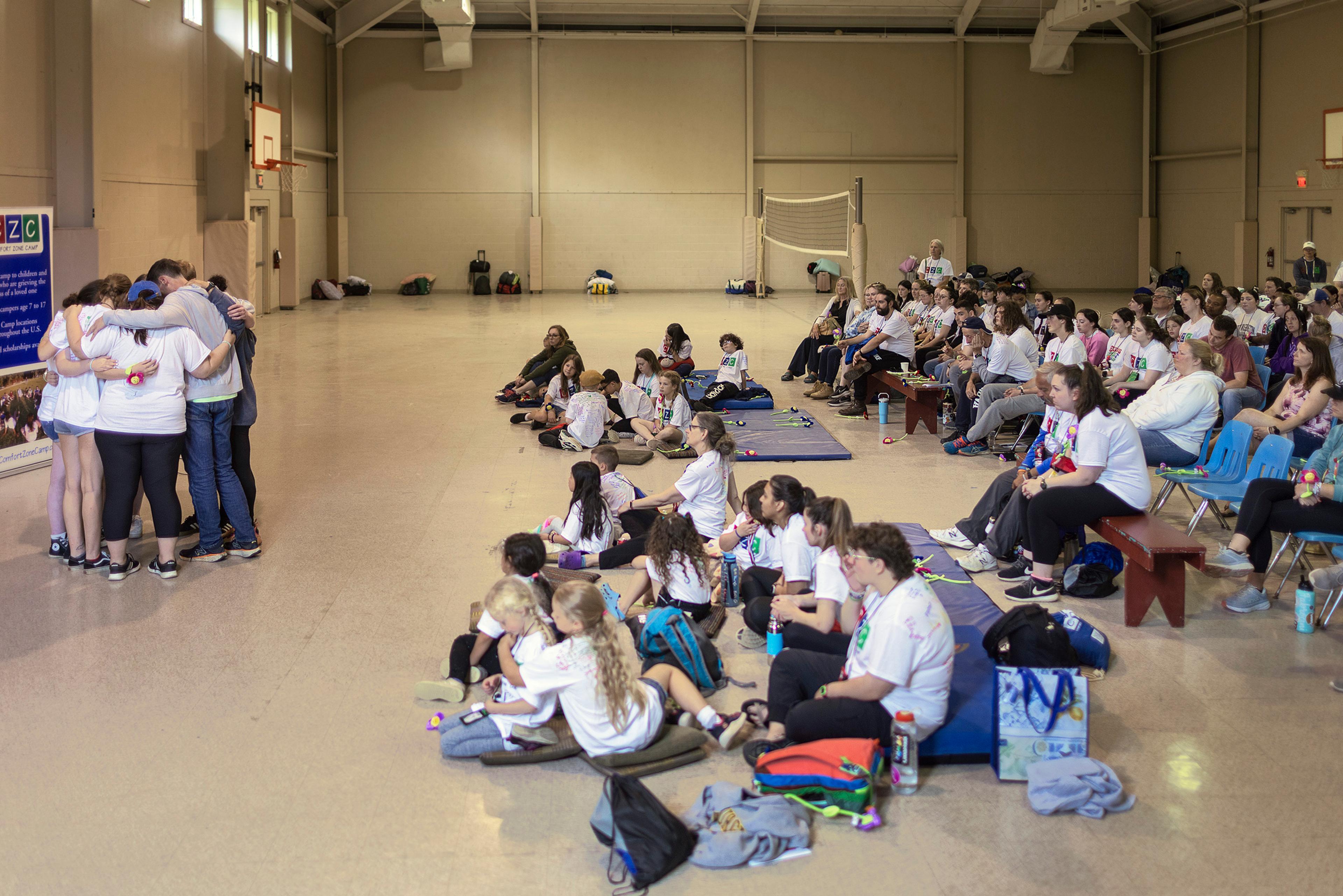 Members of a healing circle embrace after sharing who they are honoring at the final memorial service.