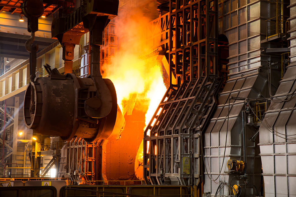 Moving hot metal to a basic oxygen furnace to make steel.