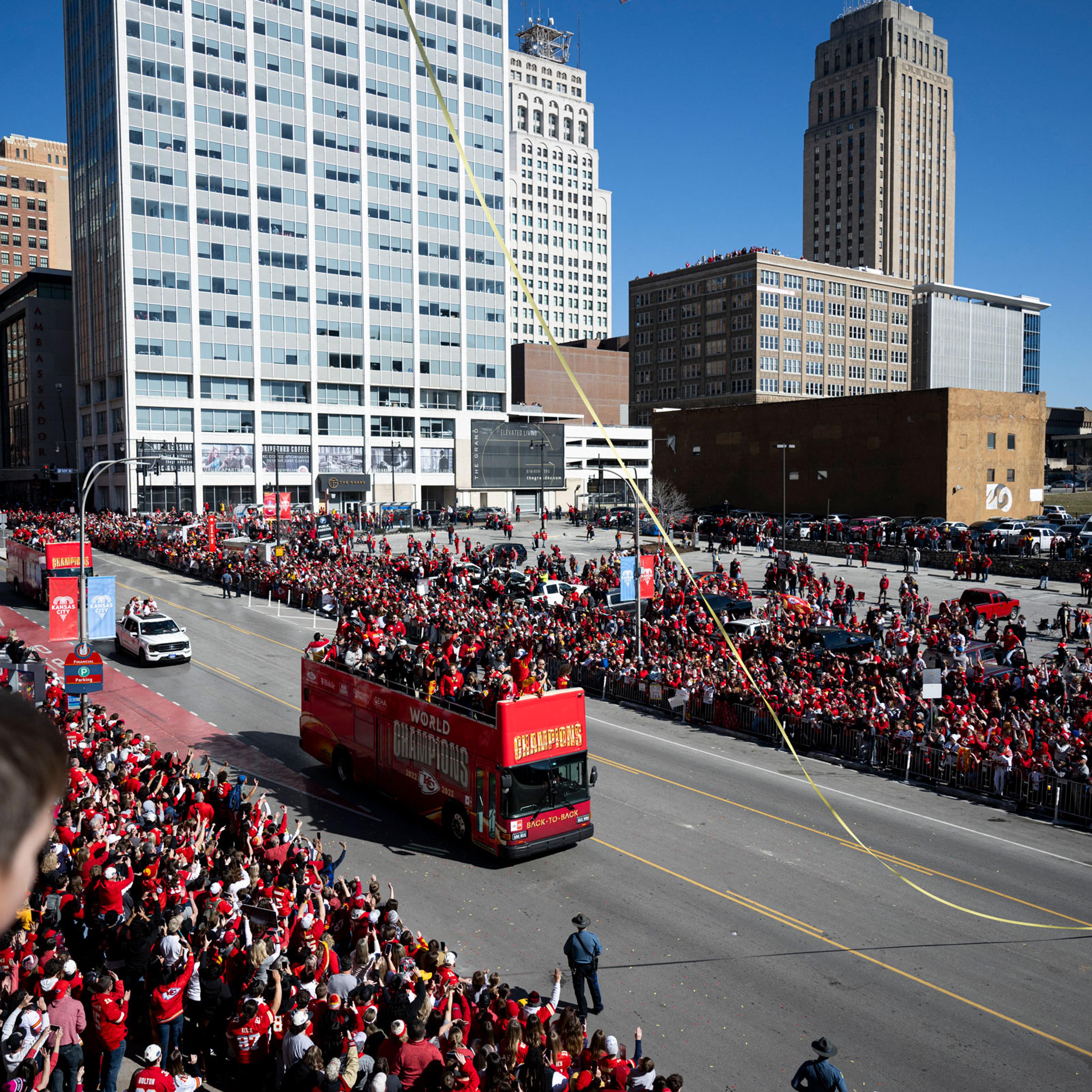 Fans watch as Kansas City Chiefs players celebrate during the Chiefs' Super Bowl LVIII victory parade in Kansas City, Mo., on Feb. 14, 2024.
