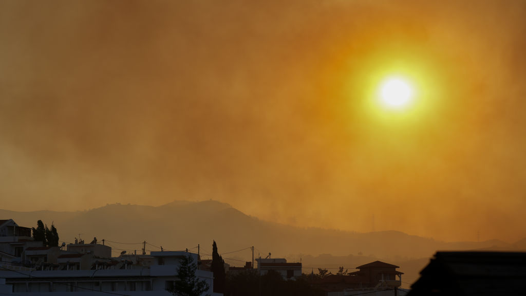 Smoke rises as teams try to extinguish wildfires on Rhodes island, Greece on July 25, 2023.