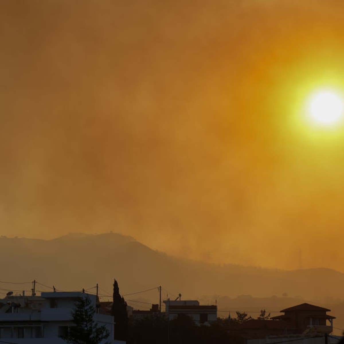 Smoke rises as teams try to extinguish wildfires on Rhodes island, Greece on July 25, 2023.