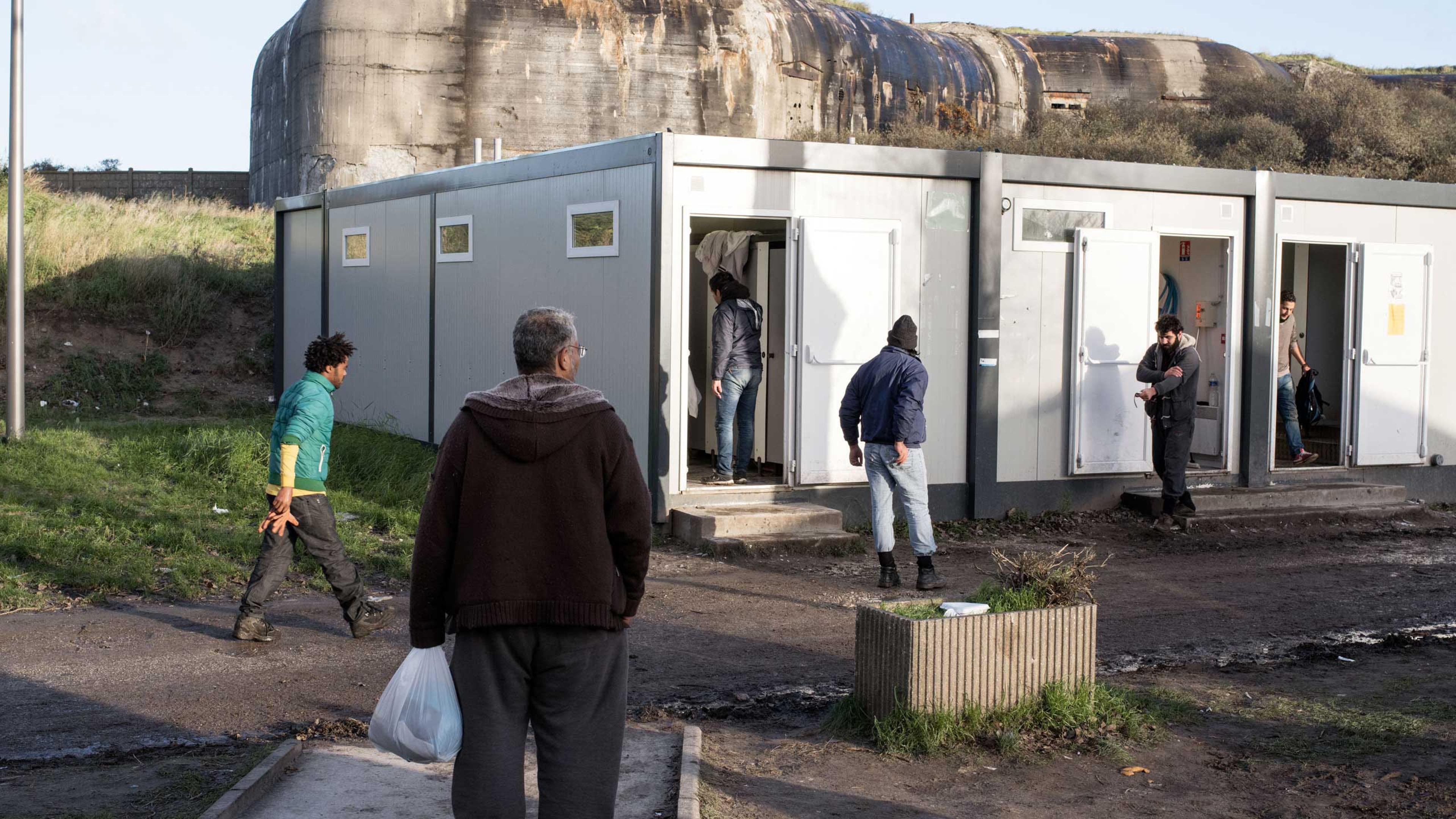 Facilities, including showers and mobile phone rechargers, are available to migrants during the day at the Jules Ferry Center in Calais, France, Nov. 25, 2015.