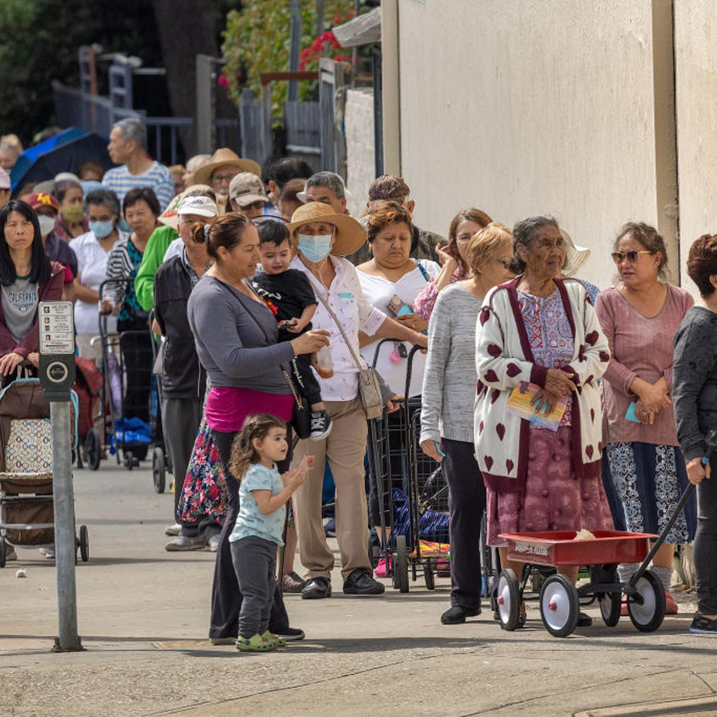 People attend a food distribution organized by embattled Los Angeles City Council member Kevin de León, who was recorded making racist remarks last fall, in Los Angeles