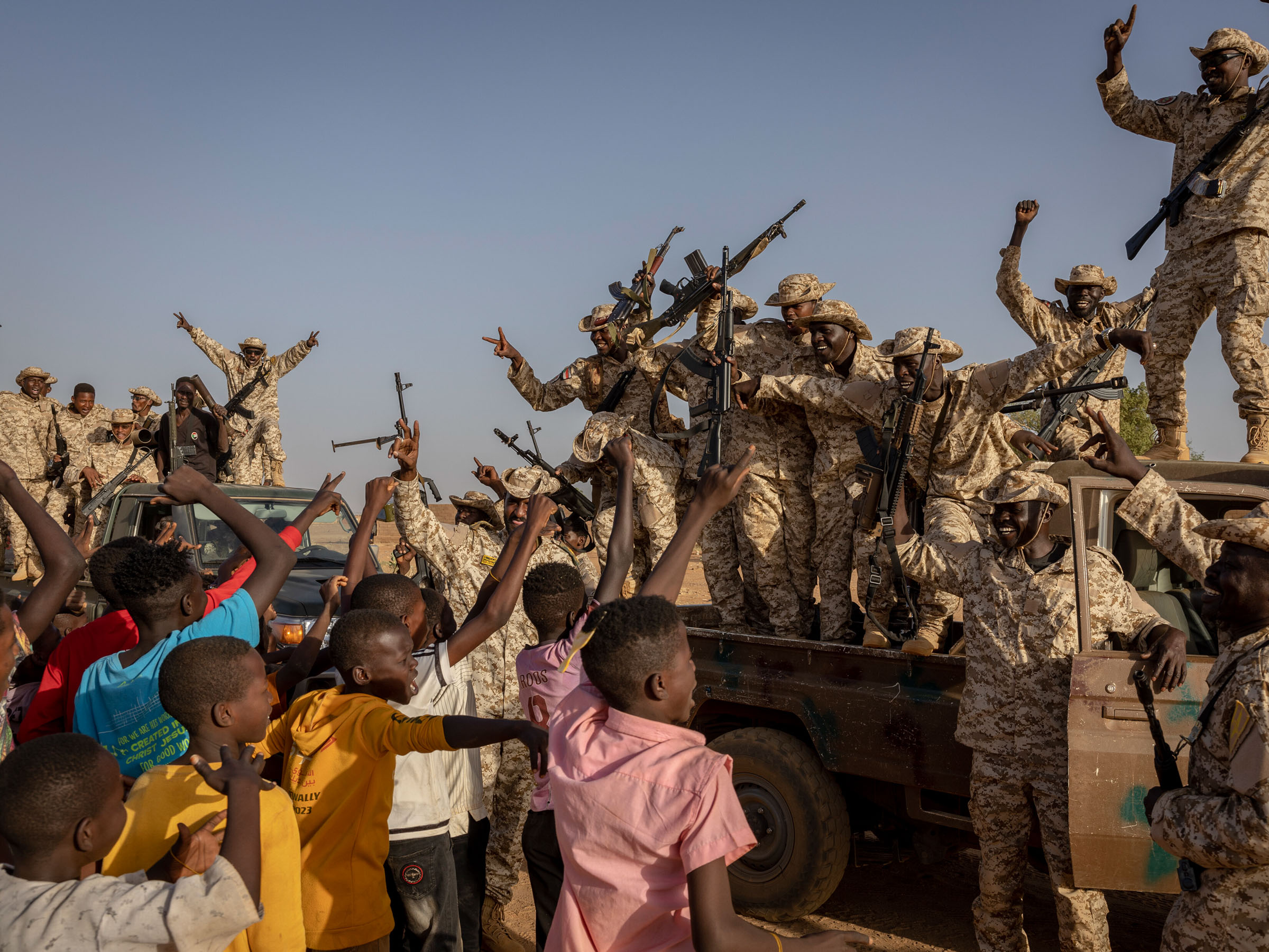 Youths cheer members of the Sudanese military during a demonstration in Omdurman, outside Khartoum, on April 24, 2024. (Ivor Prickett/The New York Times)