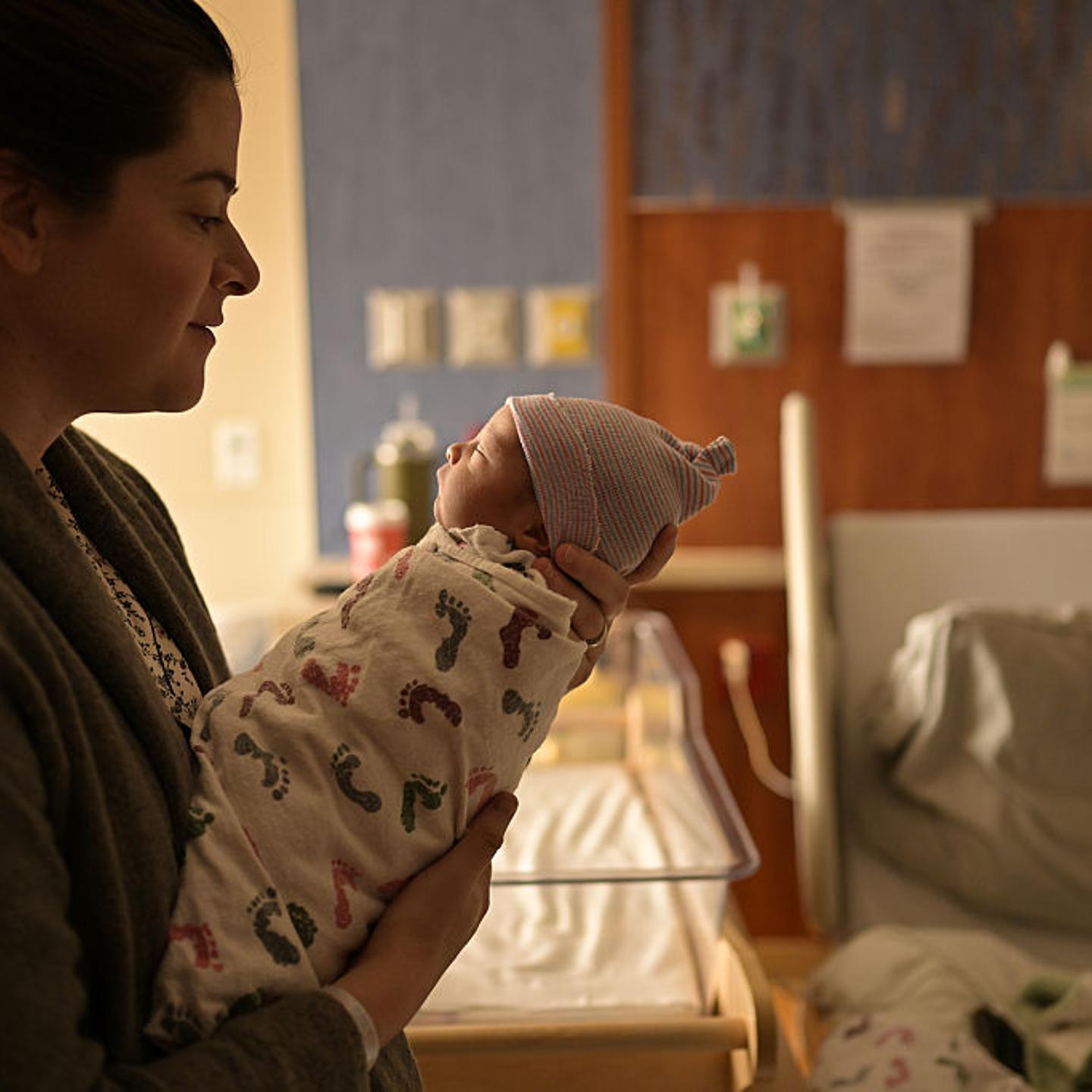 A mother lulls her newborn baby at Saint Joseph Hospital in Denver, Colorado on April 1, 2025.