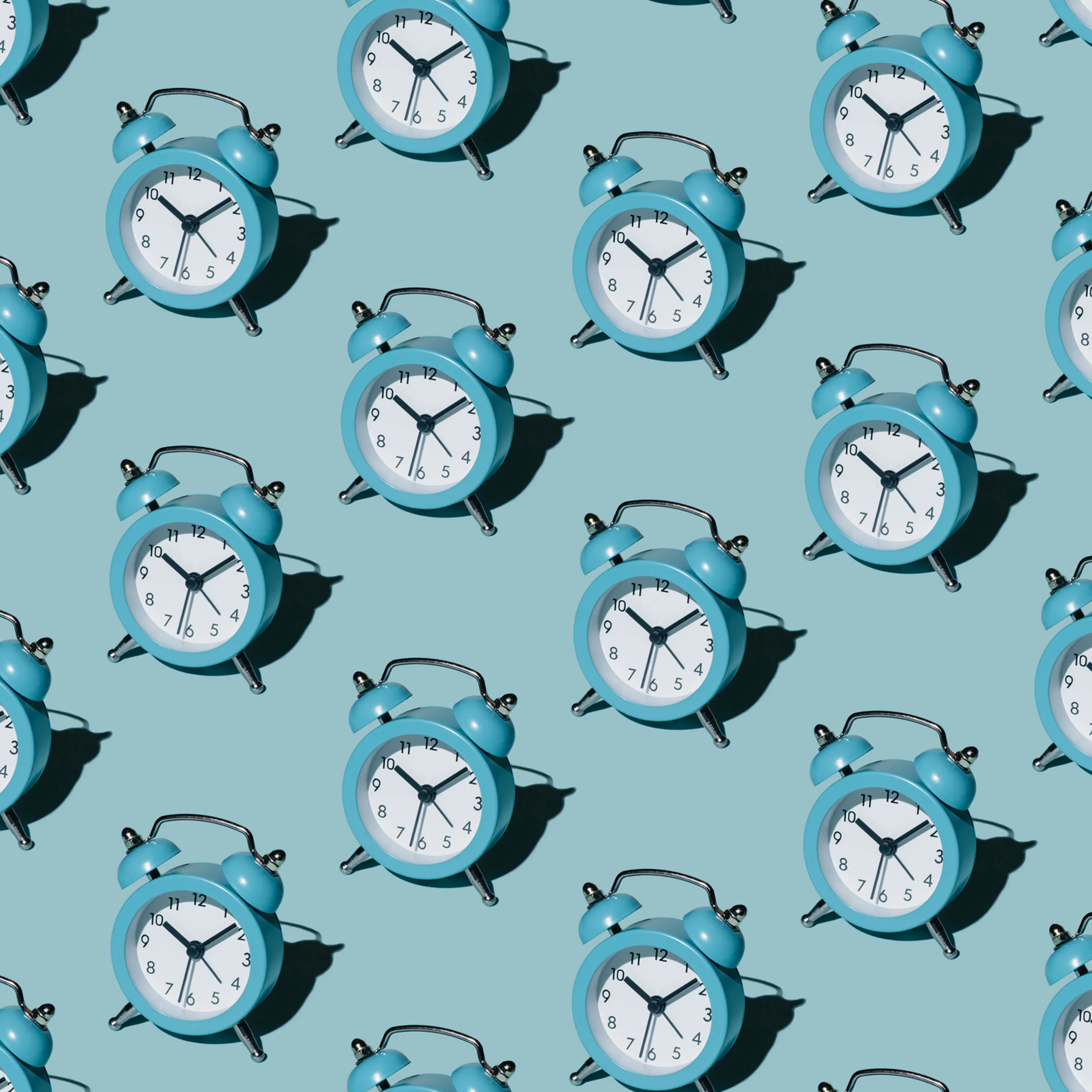 Pattern of alarm clocks on a blue background