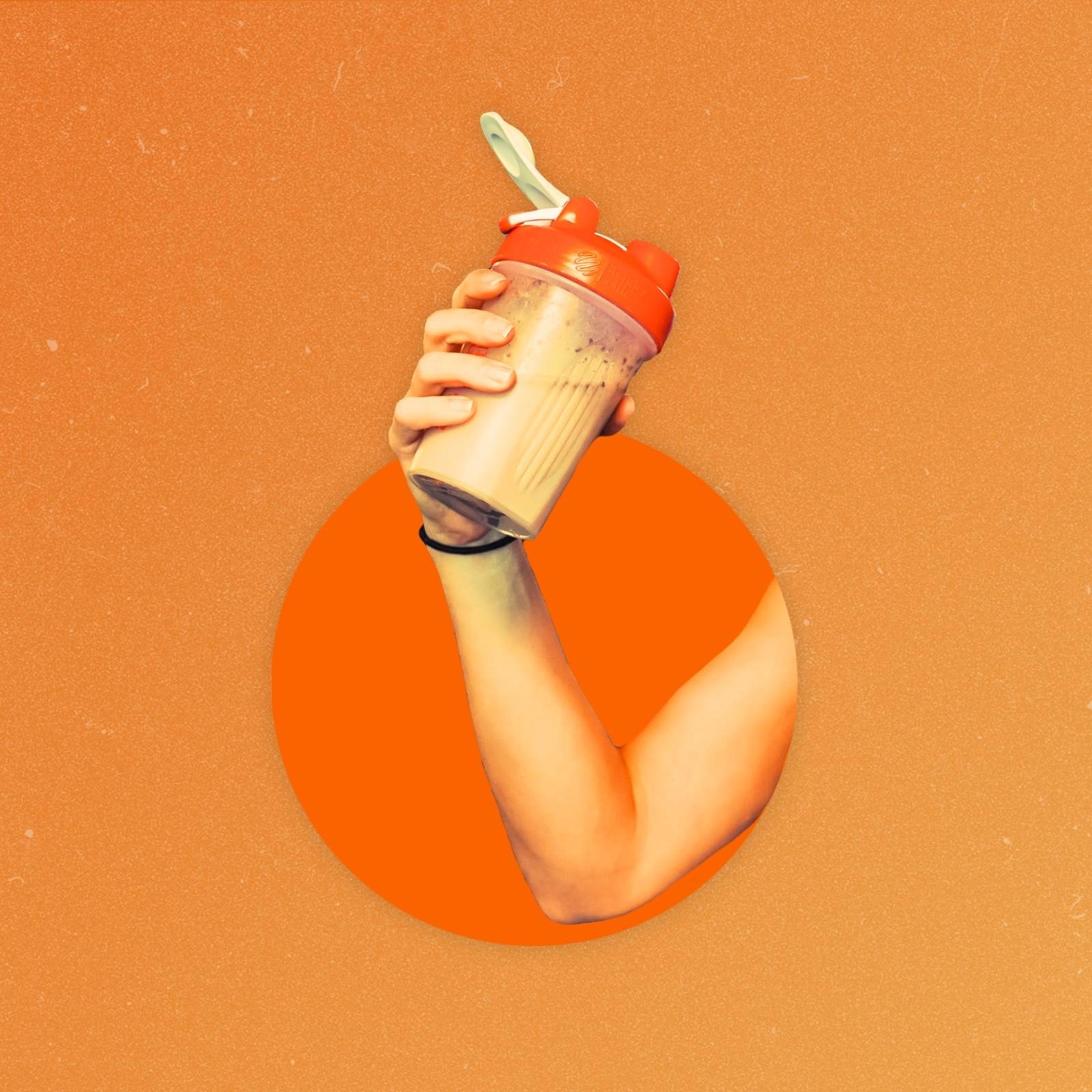 An arm coming out of a hole holding a tumbler full of a protein drink