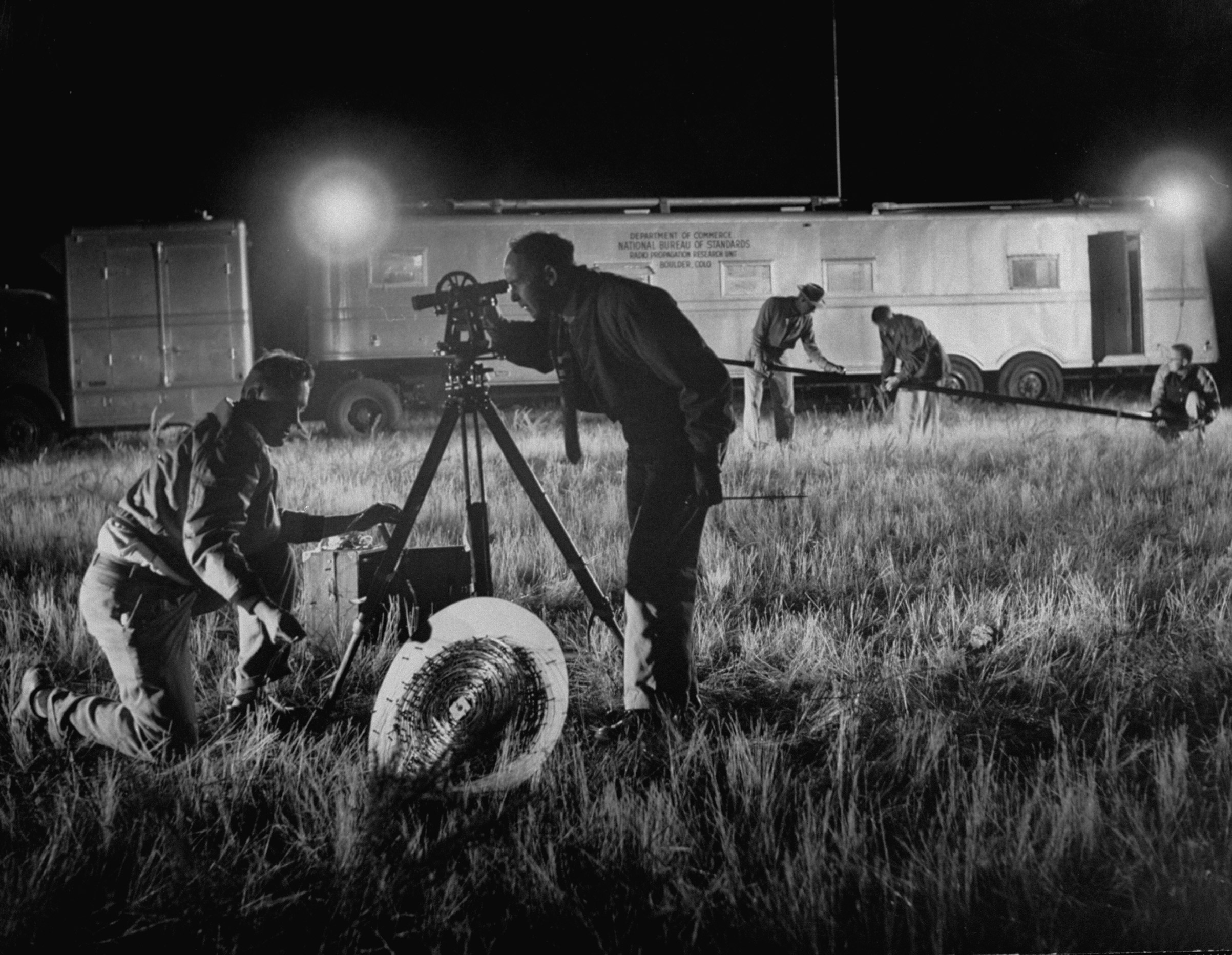 Scientists working at the field lab of the National Bureau of Standards taking measurements of Sputnik I signals.