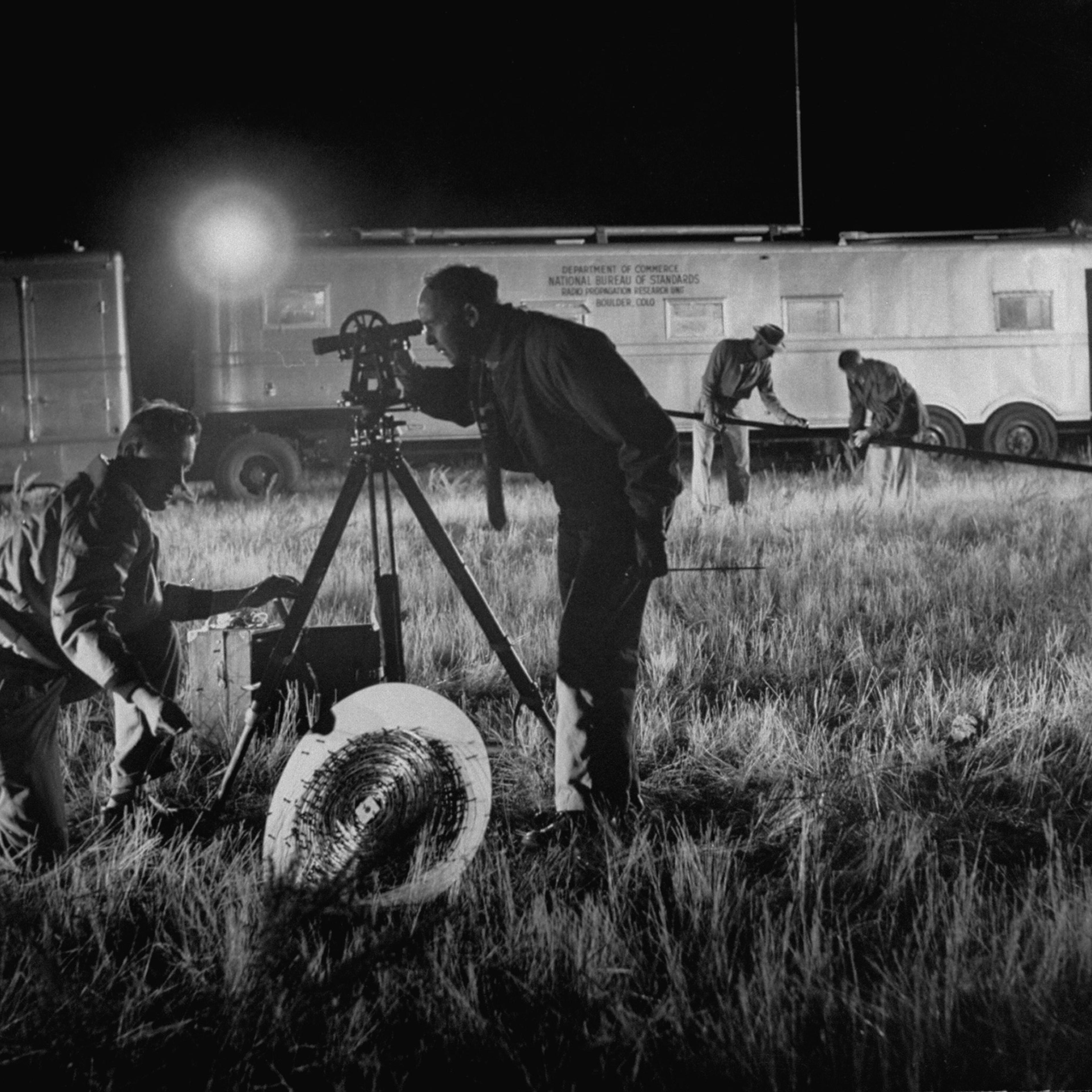 Scientists working at the field lab of the National Bureau of Standards taking measurements of Sputnik I signals.