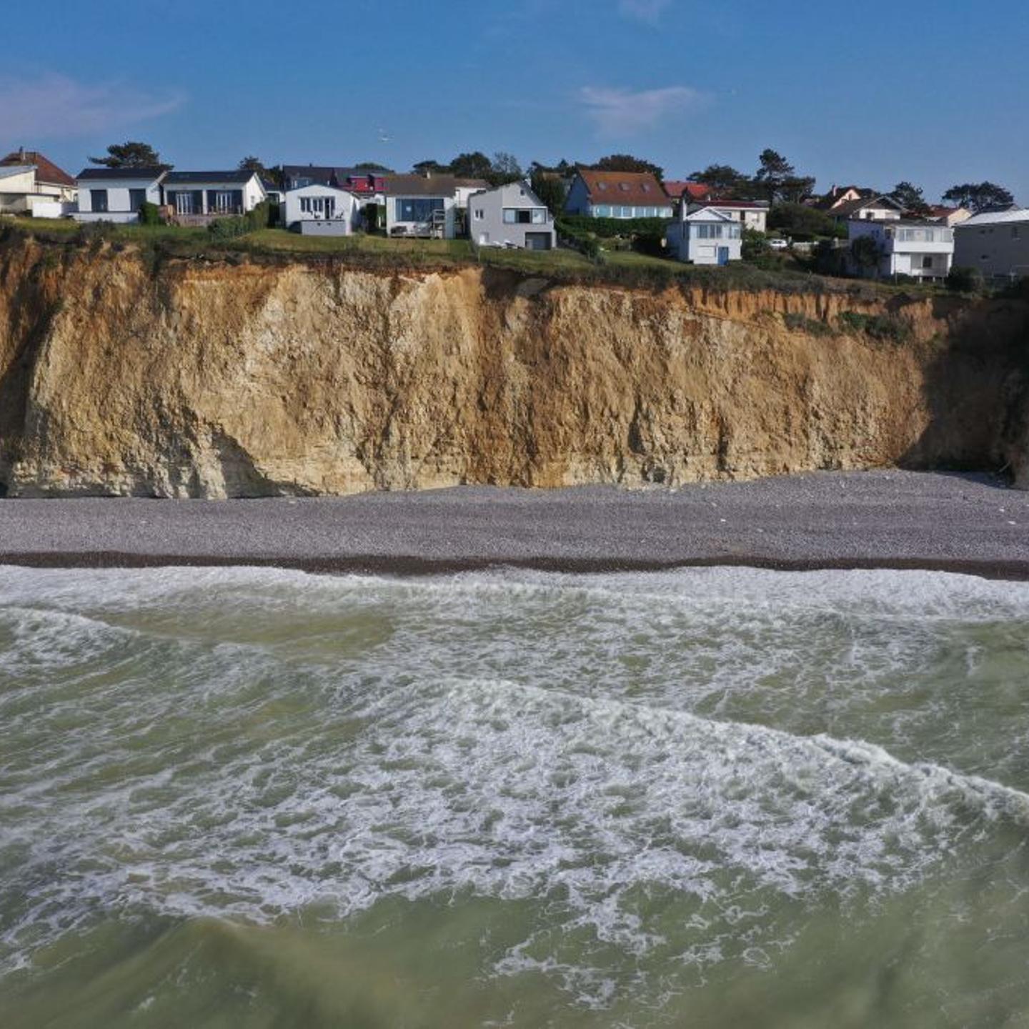 Global warming, accompanied by rising sea levels, increases risk of flooding, erosion, and cliff collapse on the Normandy coast in France, as shown on June 22, 2022.