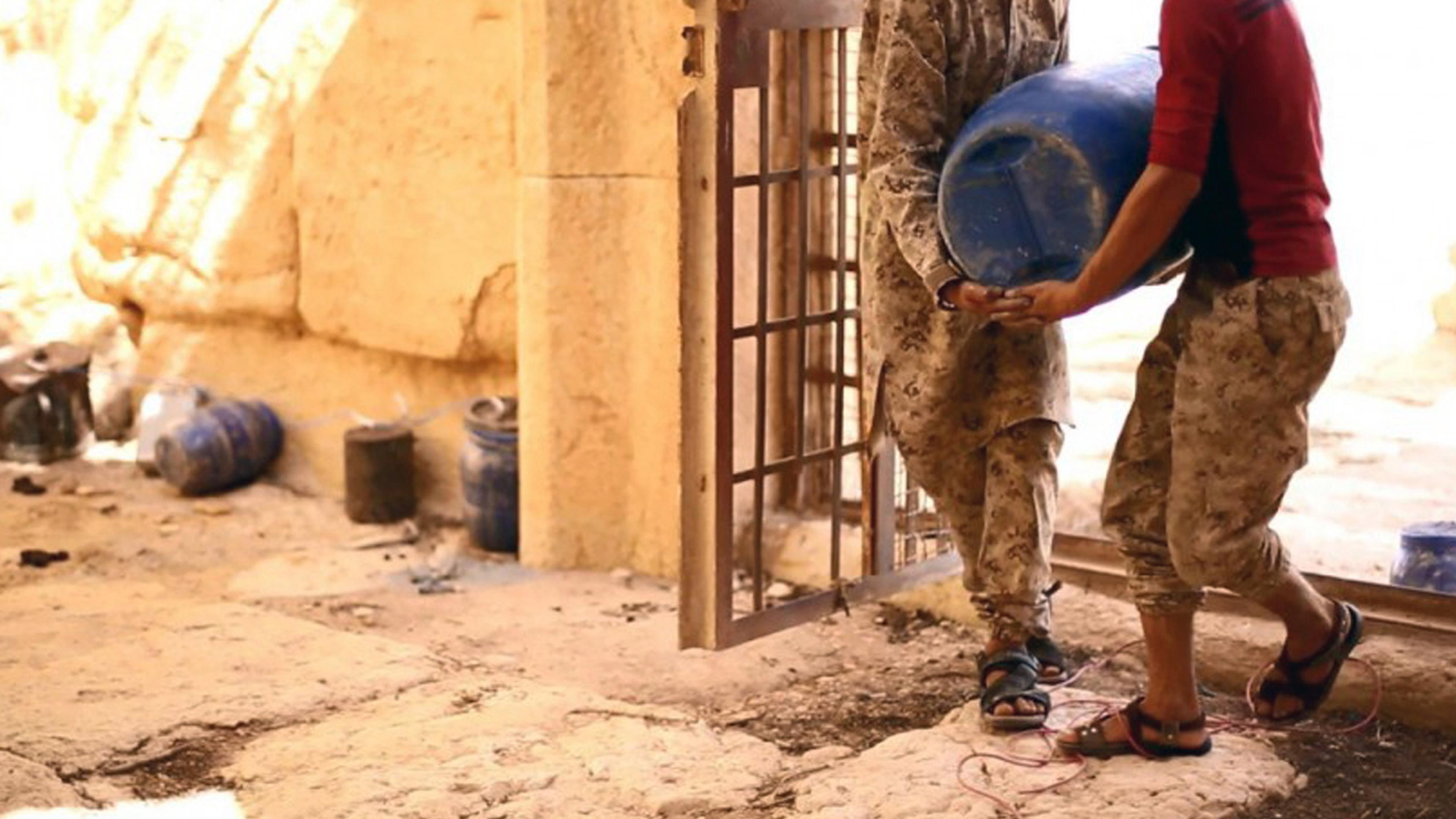 This undated photo released Tuesday, Aug. 25, 2015 on a social media site used by Islamic State militants, which has been verified and is consistent with other AP reporting, shows shows militants laying explosives in the 2,000-year-old temple of Baalsham