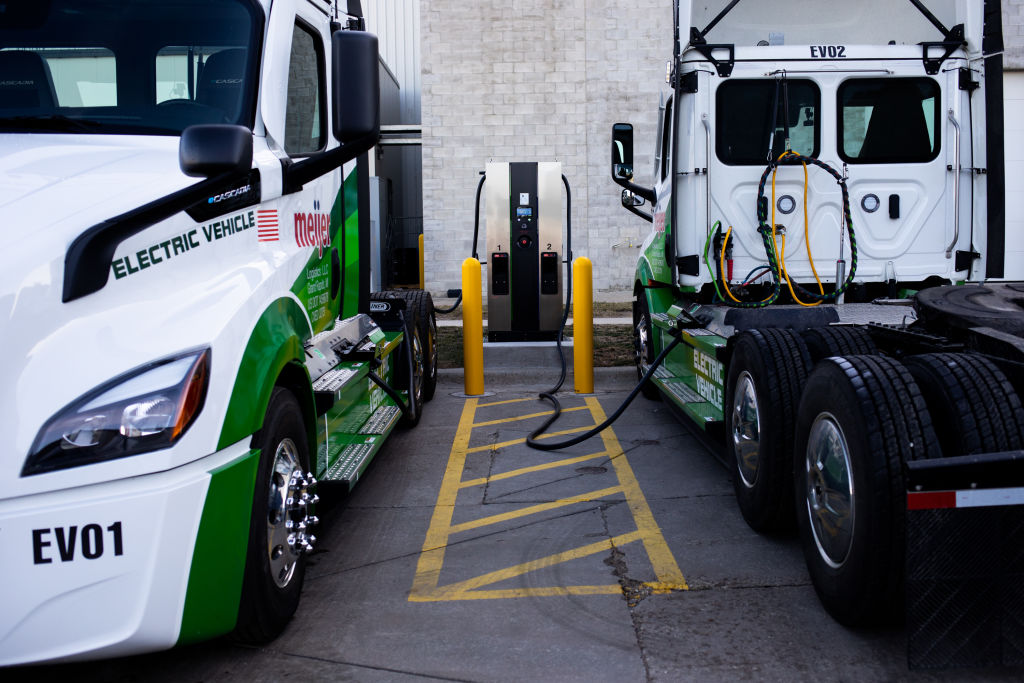 Daimler Freightliner eCascadia all-electric semitrucks charge at a Meijer distribution center in Lansing, Michigan, on Feb. 14, 2023.