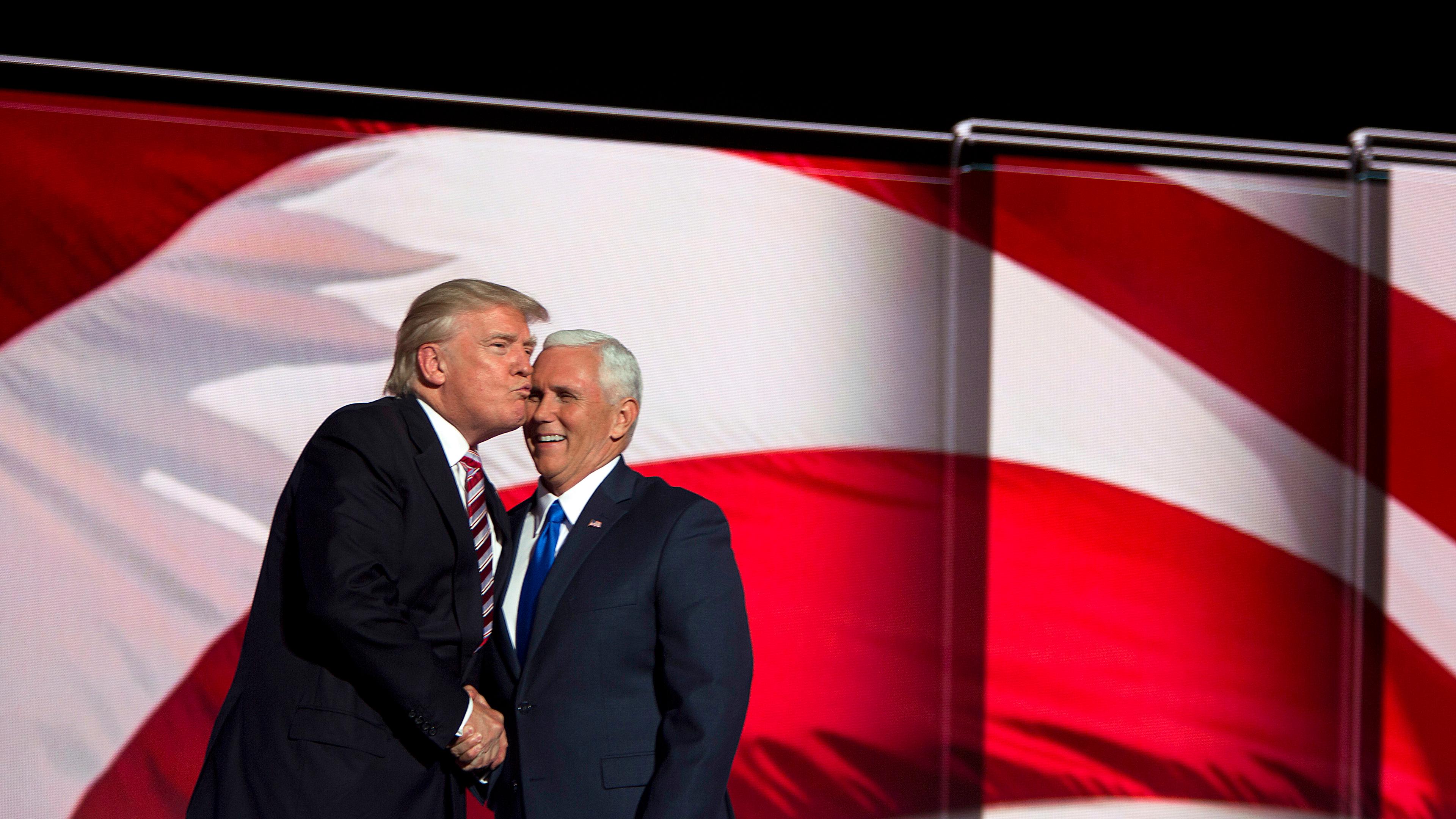 Donald Trump kisses running mate Indiana Gov. Mike Pence at the Republican National Convention on July 20, 2016, in Cleveland.