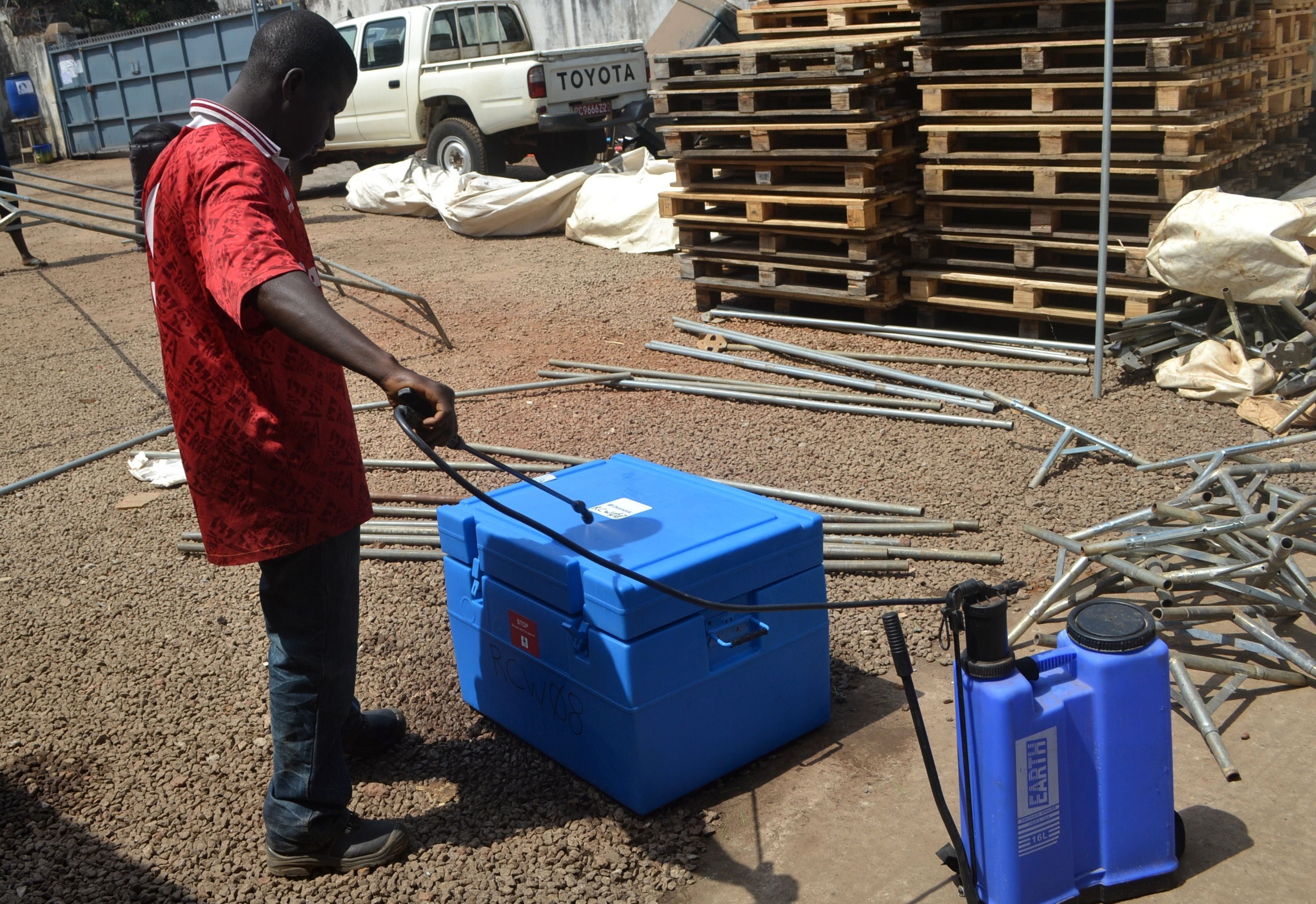 A man desinfects a warehouse of the Swiss branch of the NGO Medecins sans Frontieres in Conakry, Guinea.