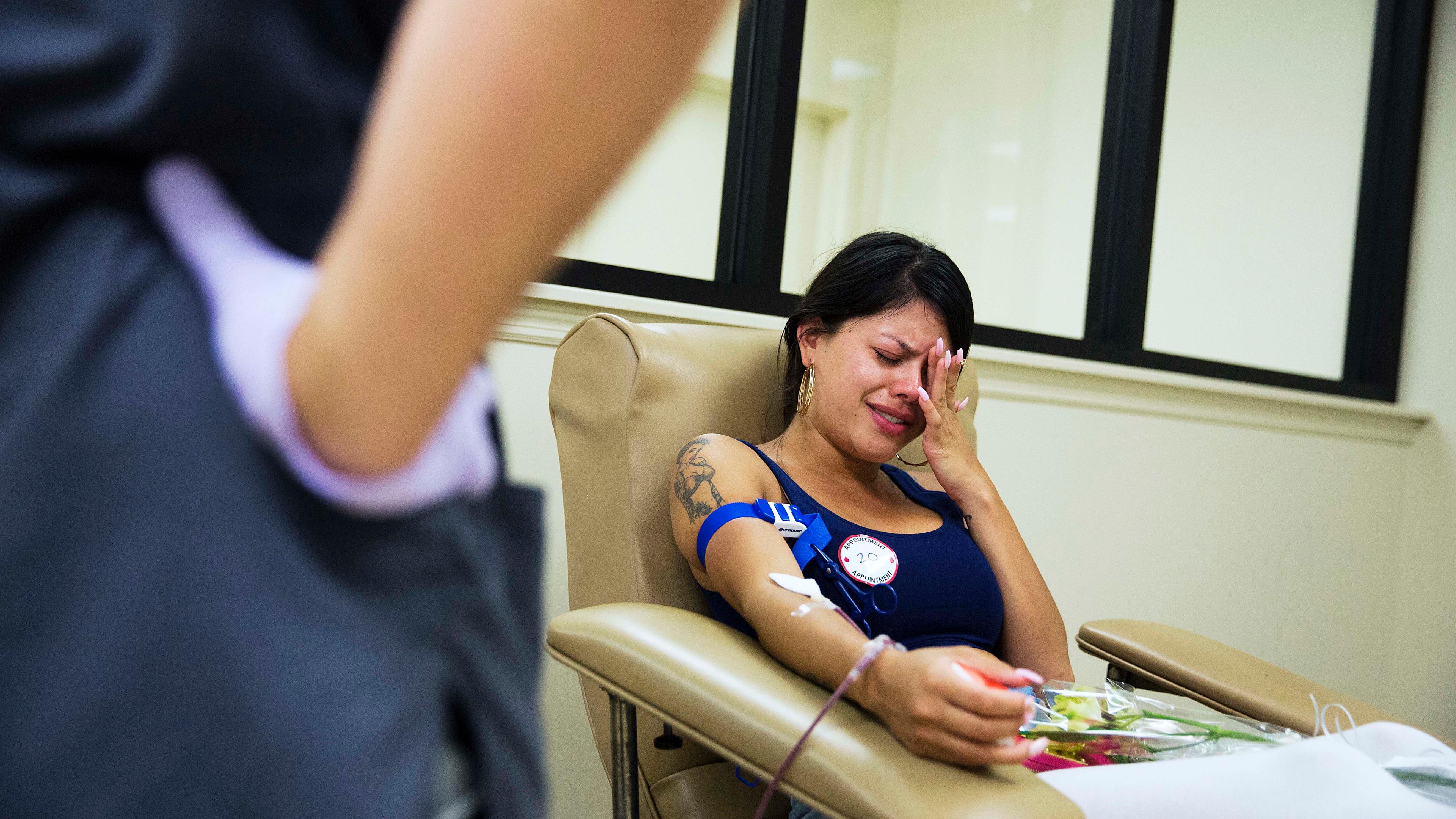 Tatiana Osorio cries while giving blood at the OneBlood blood center near the mass shooting at a nightclub in Orlando, Fla., on June 13, 2016. Osorio lost three friends in the shooting.